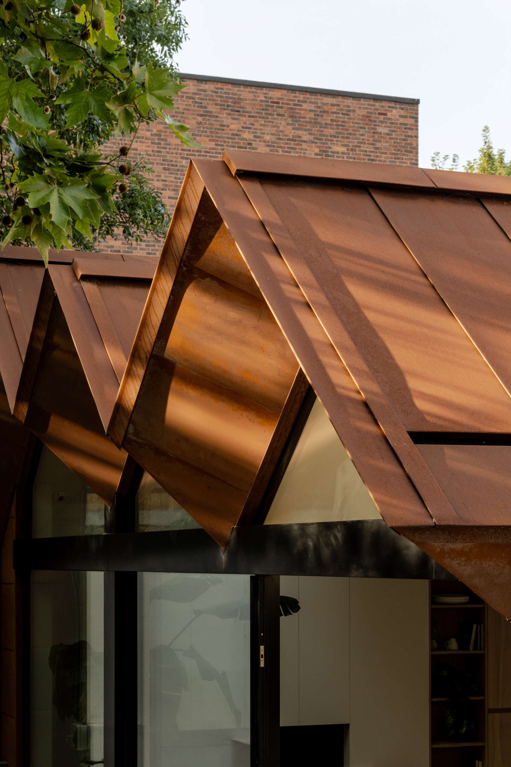 See how Corten steel was used on the extension of Thirsk Cottage to echo the warm terracotta roof tiles of the original Highgate cottage.