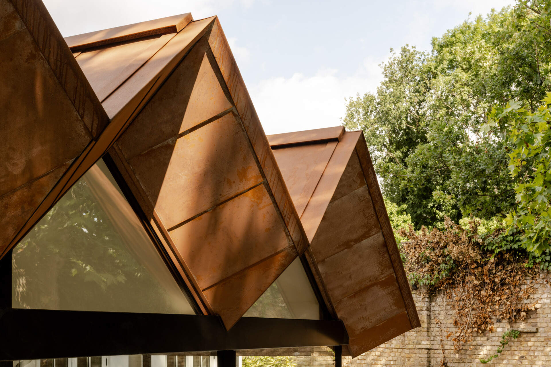 See how Corten steel was used on the extension of Thirsk Cottage to echo the warm terracotta roof tiles of the original Highgate cottage.