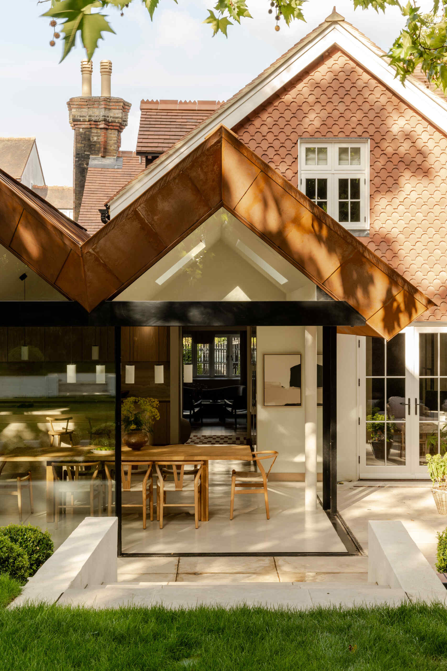 Take a look at the patio and garden connection at Thirsk Cottage, where expansive glazing opens the contemporary extension towards the greenery beyond.