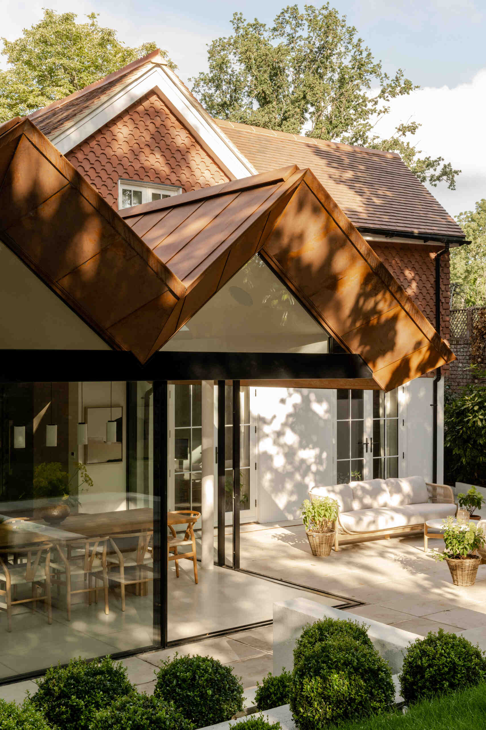 See how Corten steel was used on the extension of Thirsk Cottage to echo the warm terracotta roof tiles of the original Highgate cottage.