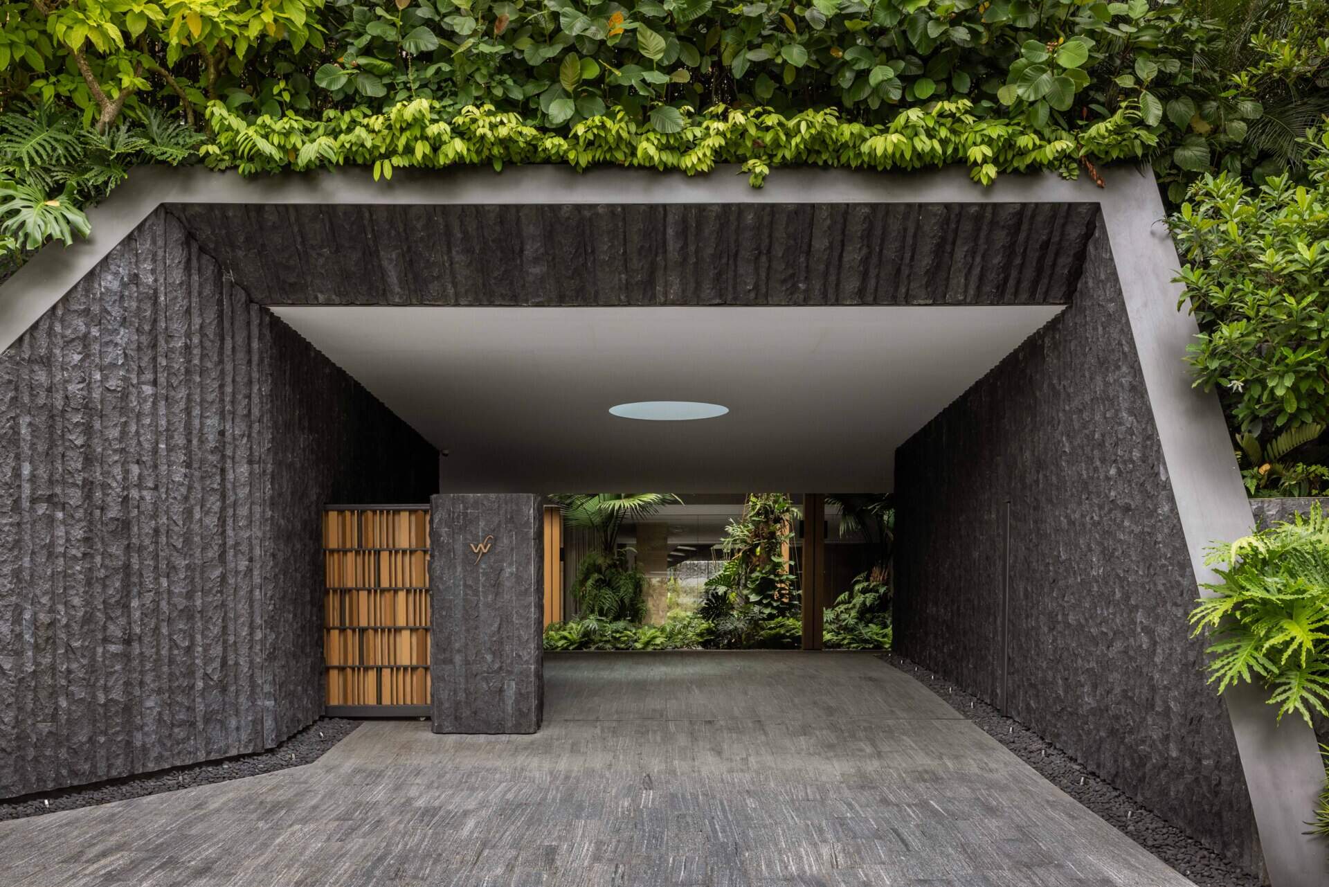 House Above The Trees by Wallflower Architecture + Design is a Singapore home shaped by water gardens, tall atriums, lush planting, filtered screens and views towards the surrounding forest.