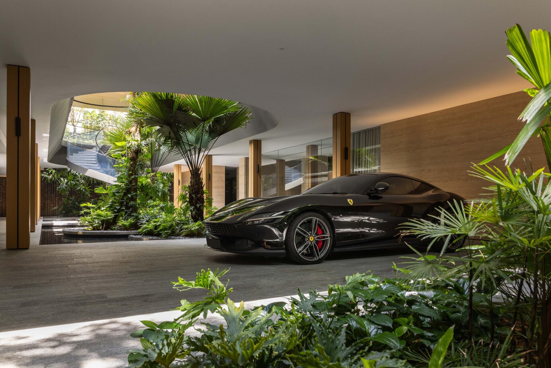 Two tall atriums bring trees, water, daylight and open sky into the heart of this Singapore family home.