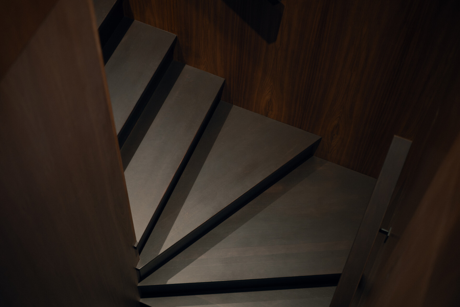 The staircase connects Chalet Moraine's upper living spaces with the basement, continuing the home's carefully structured circulation through its different levels.