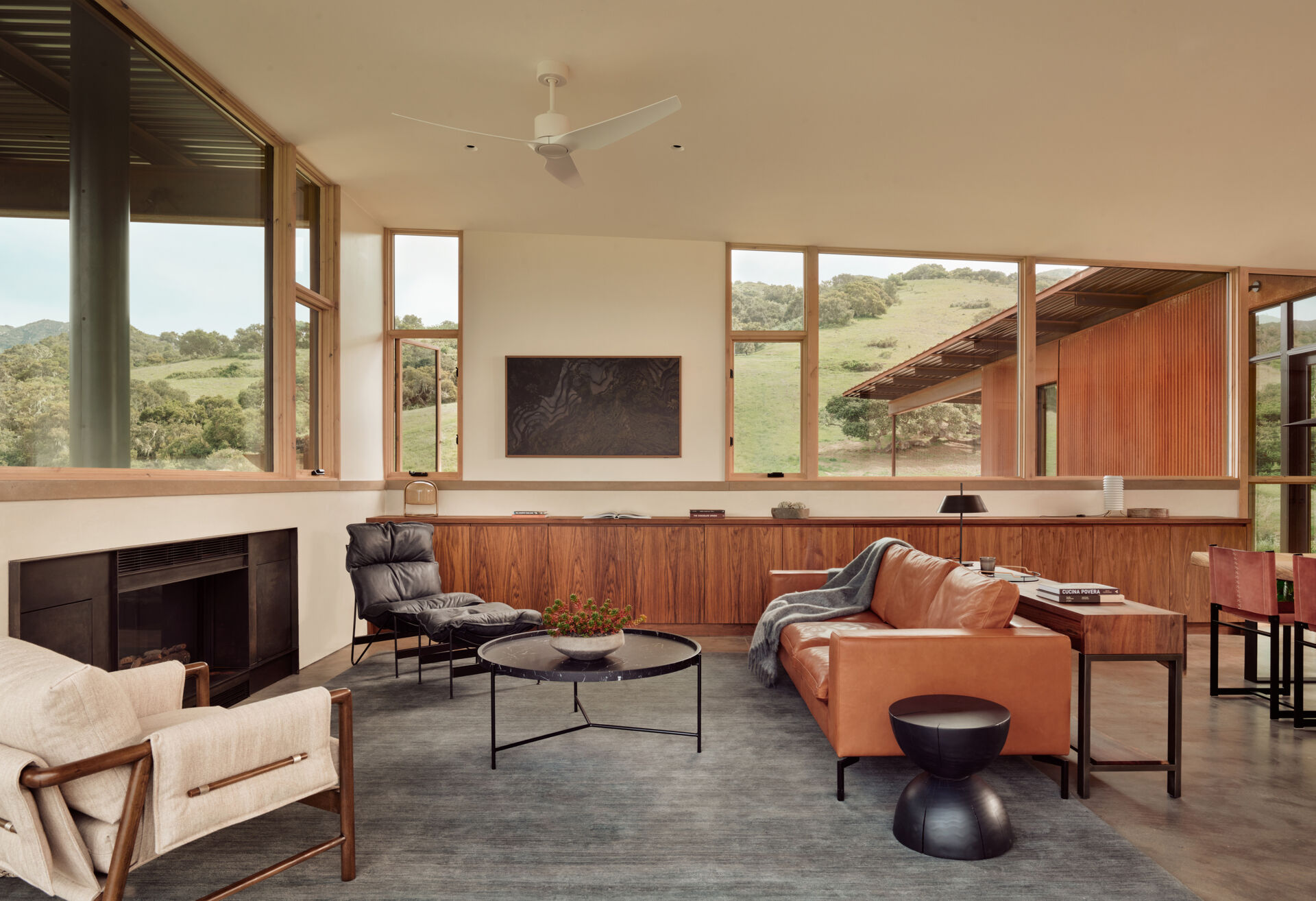 White oak, hand-troweled plaster and burnished concrete create a warm, understated living room at Clayton Korte’s Vineyard Residence, with expansive glazing bringing the hillside views inside.
