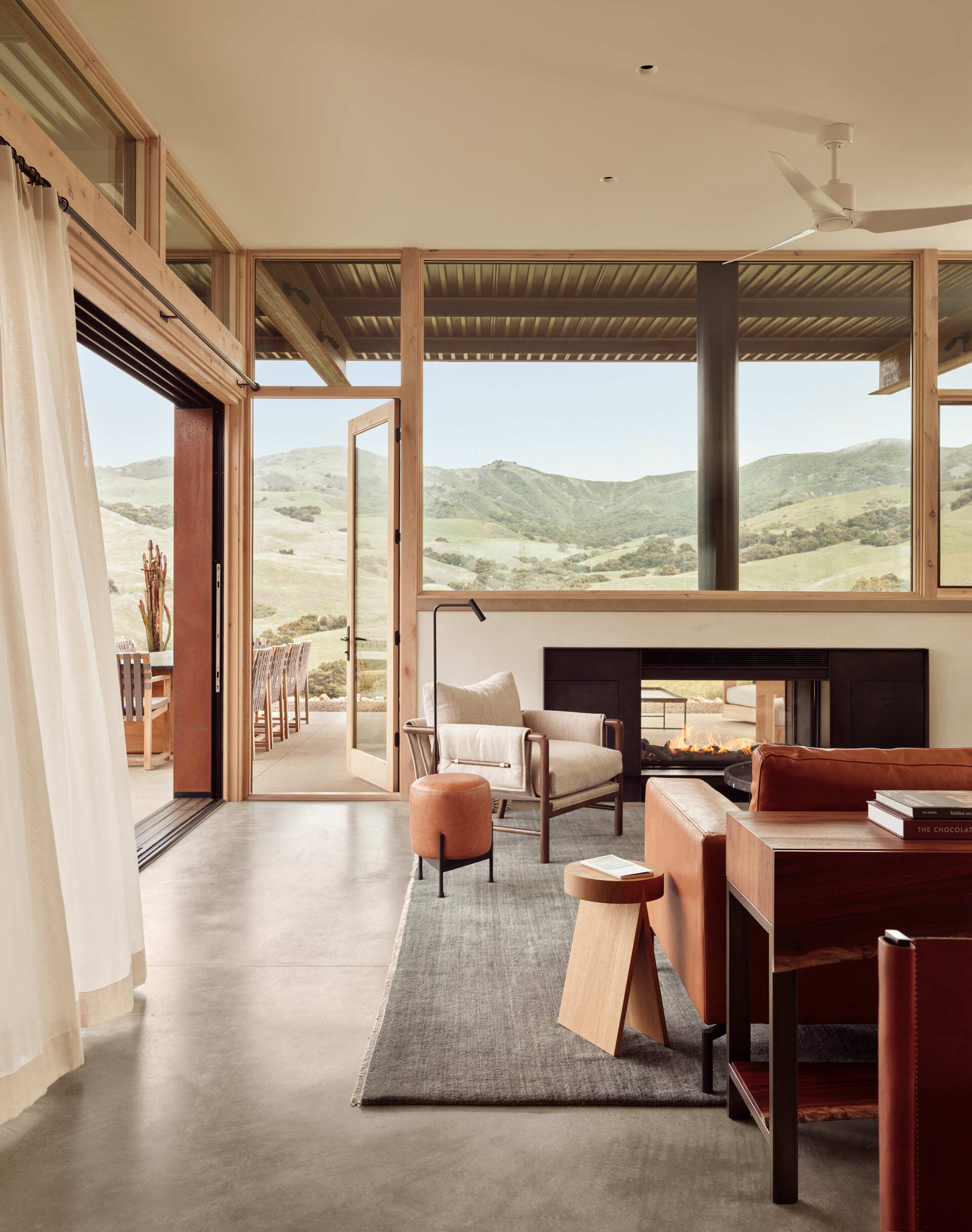 White oak, hand-troweled plaster and burnished concrete create a warm, understated living room at Clayton Korte’s Vineyard Residence, with expansive glazing bringing the hillside views inside.