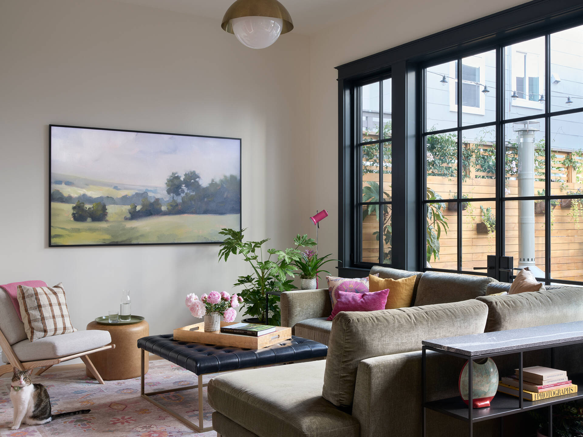 A flexible living room opens to the kitchen and dining area, with a built-in bench beside the courtyard window creating a cosy reading nook overlooking the garden.