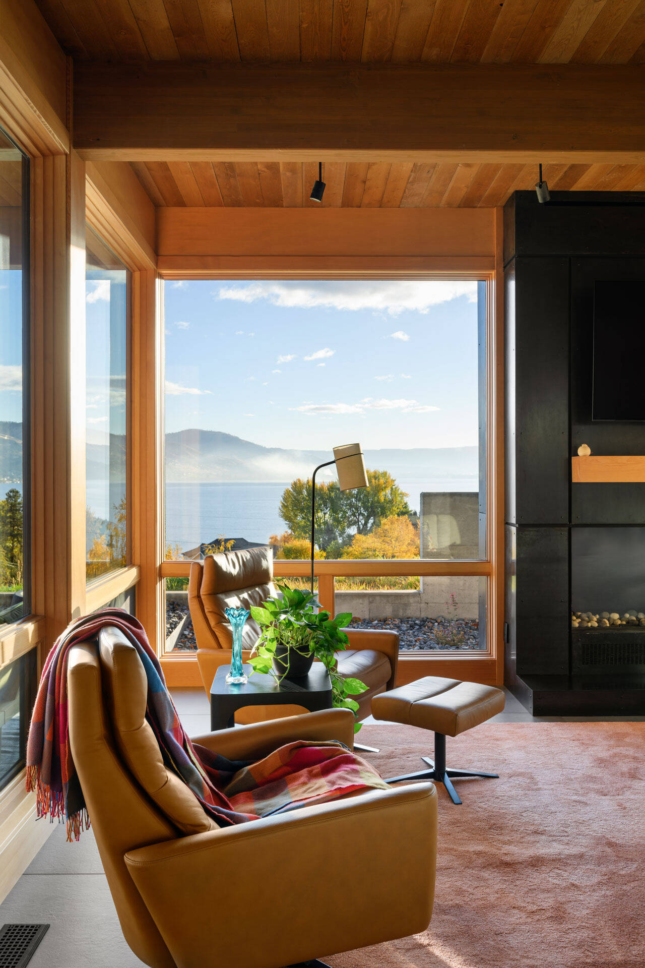 Warm timber ceilings, exposed beams, and expansive views come together in a modern living space that balances clean architecture with inviting textures.