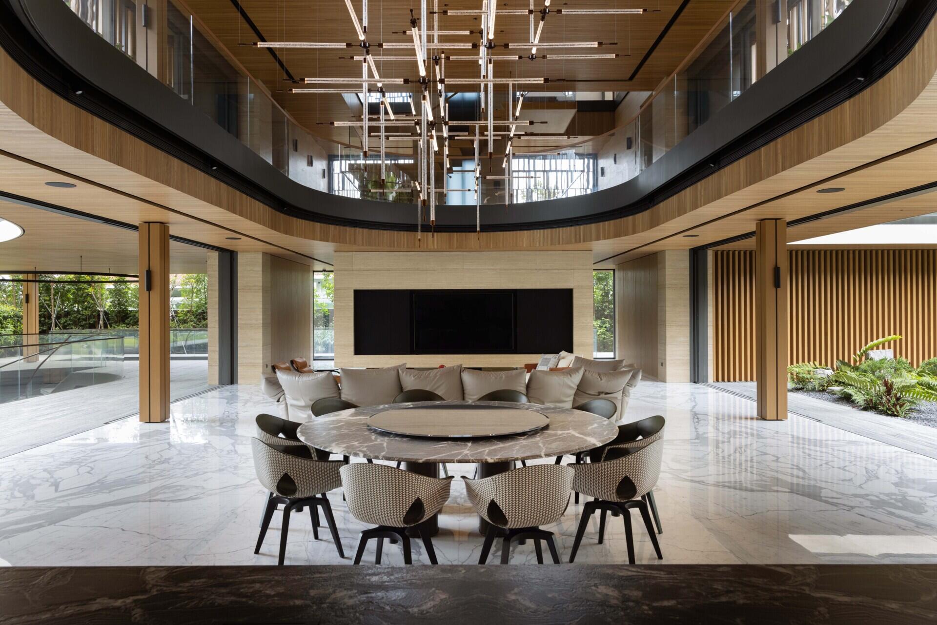Living and dining spaces surround lush water gardens, creating views of planting throughout the lower levels.