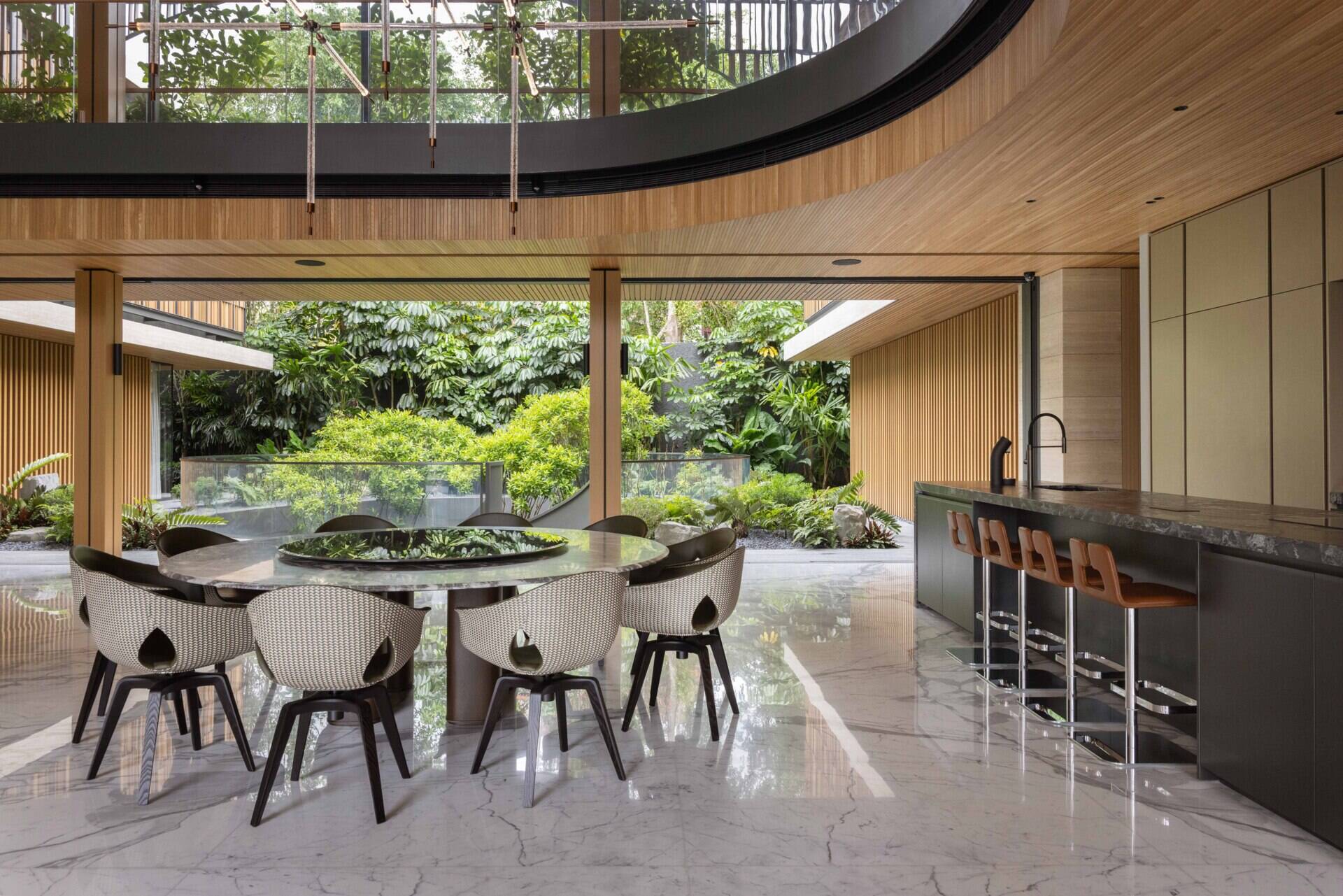 Living and dining spaces surround lush water gardens, creating views of planting throughout the lower levels.