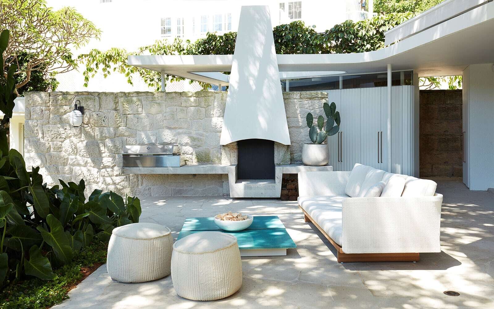 Floor-to-ceiling steel and glass doors open the communal spaces directly to outdoor lounges, a BBQ area, garden and swimming pool in this Sydney home.