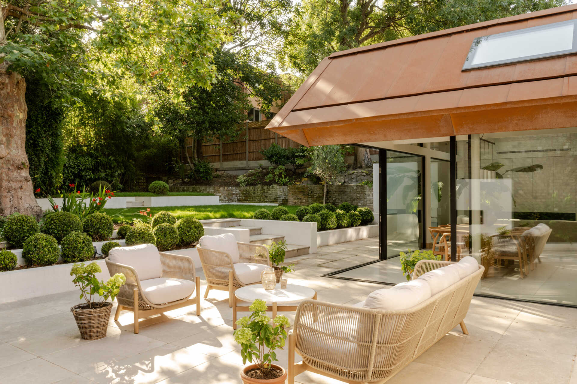 Take a look at the patio and garden connection at Thirsk Cottage, where expansive glazing opens the contemporary extension towards the greenery beyond.