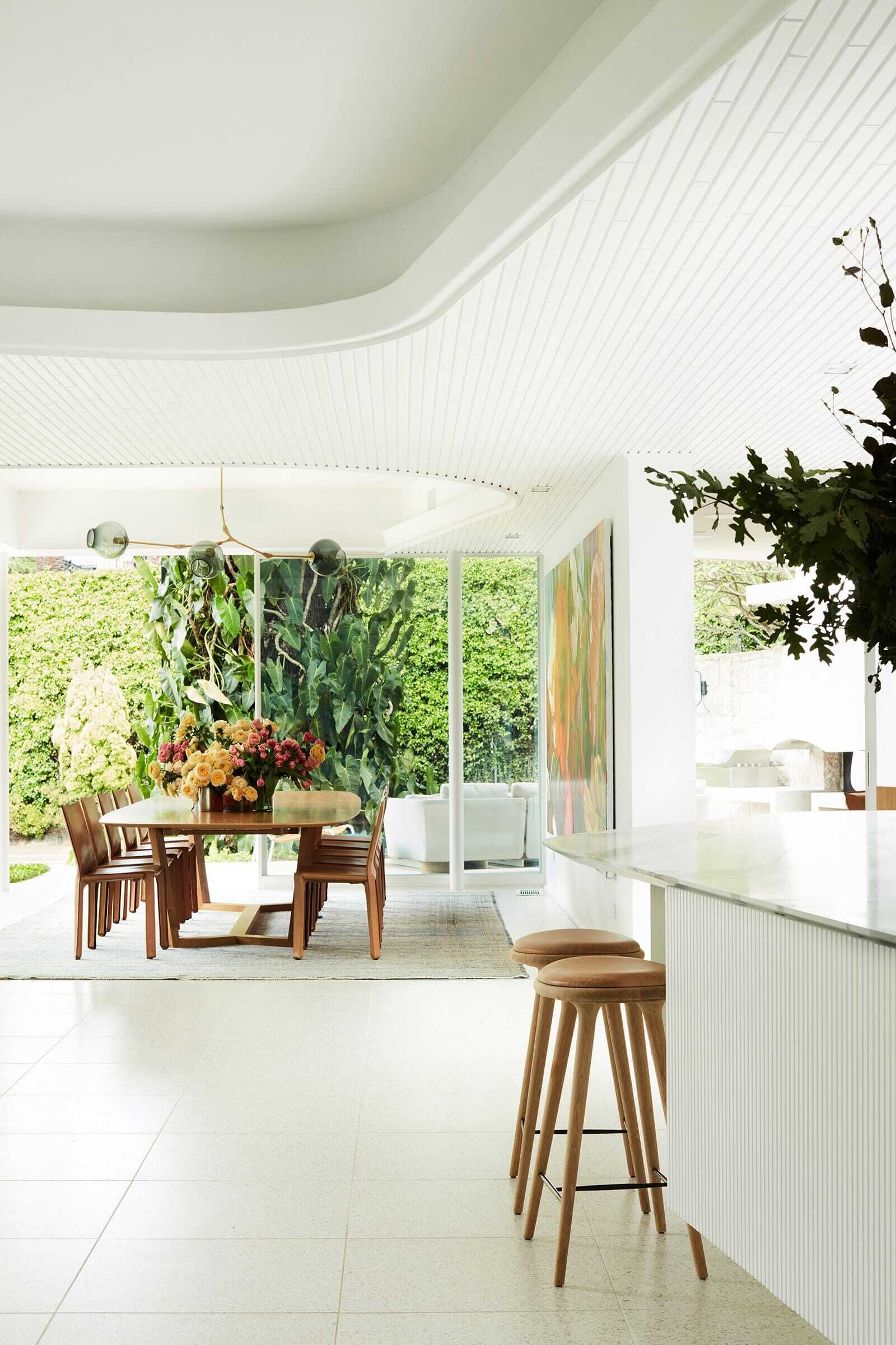 Floor-to-ceiling steel and glass doors open the communal spaces directly to outdoor lounges, a BBQ area, garden and swimming pool in this Sydney home.