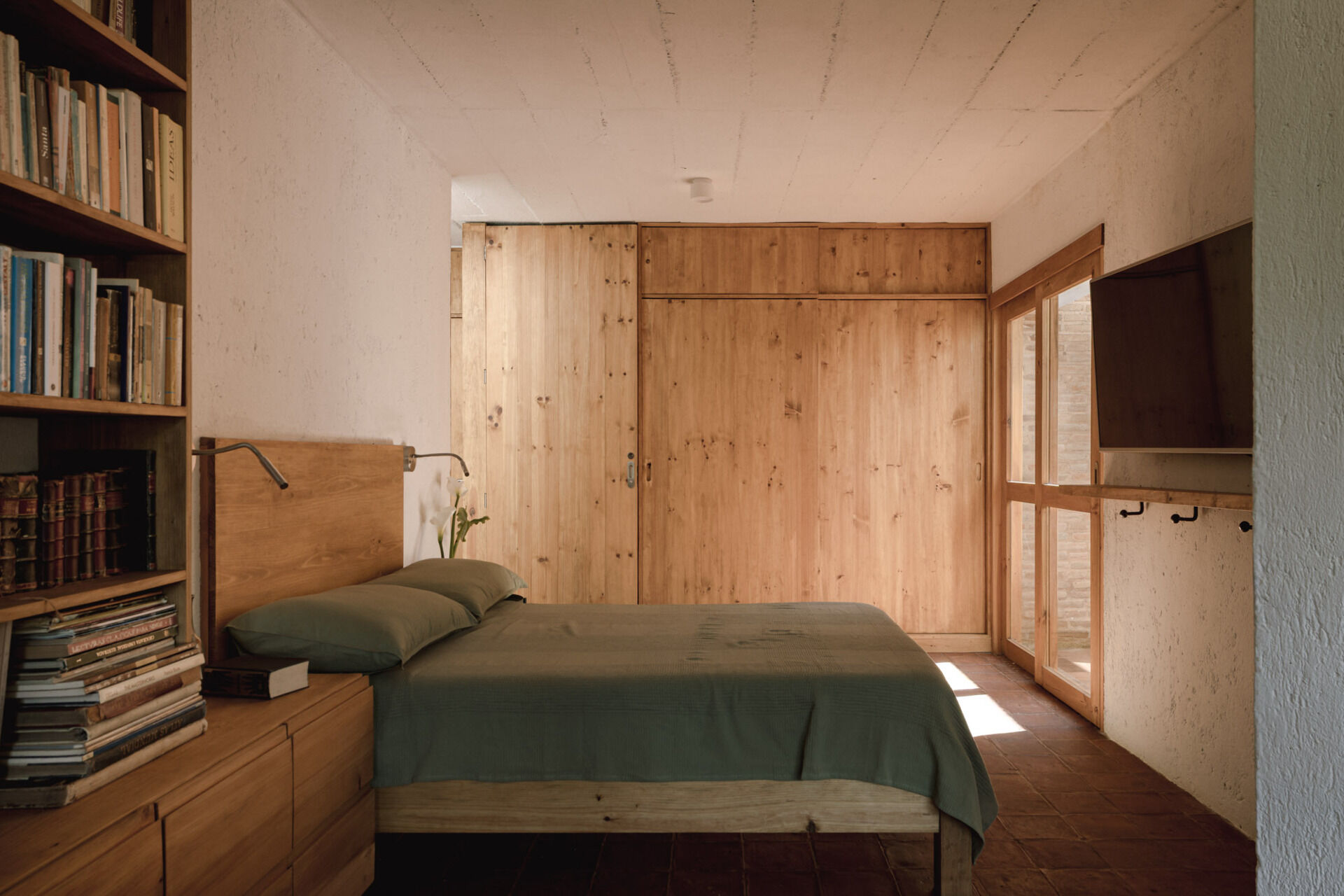 Tour the upstairs suite at Casa Amona, with cypress bookshelves, a desk overlooking the trees and a covered terrace facing the wooded hillside.