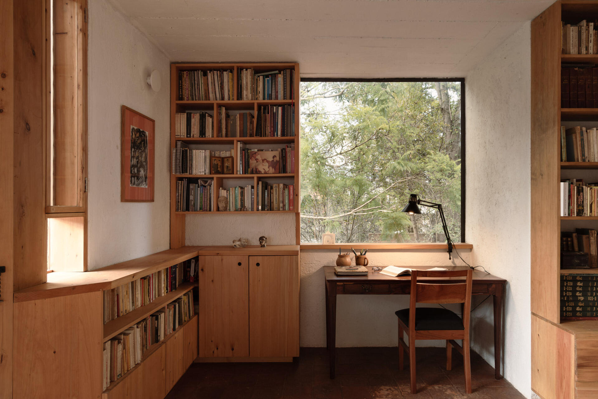 Tour the upstairs suite at Casa Amona, with cypress bookshelves, a desk overlooking the trees and a covered terrace facing the wooded hillside.