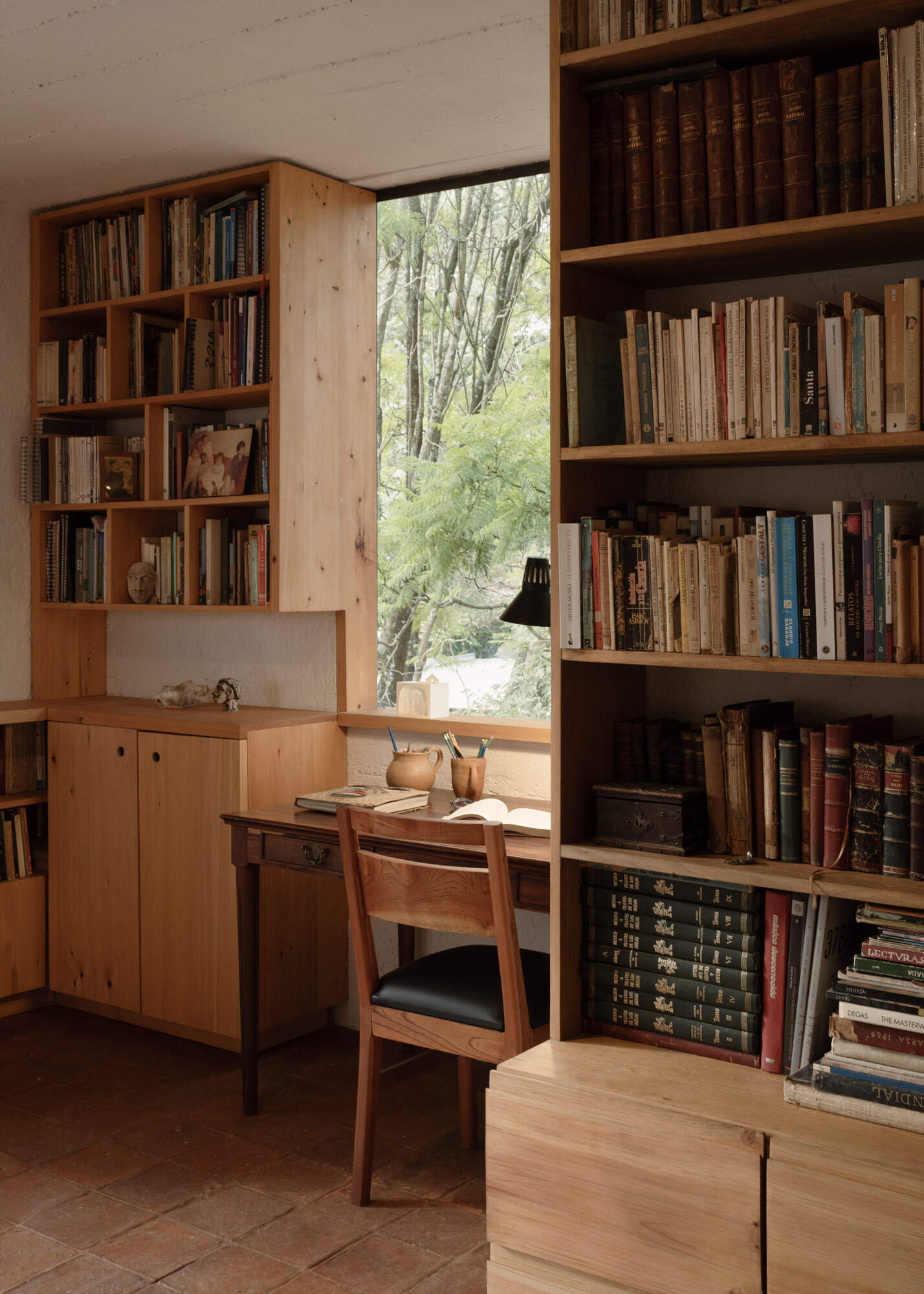 Tour the upstairs suite at Casa Amona, with cypress bookshelves, a desk overlooking the trees and a covered terrace facing the wooded hillside.