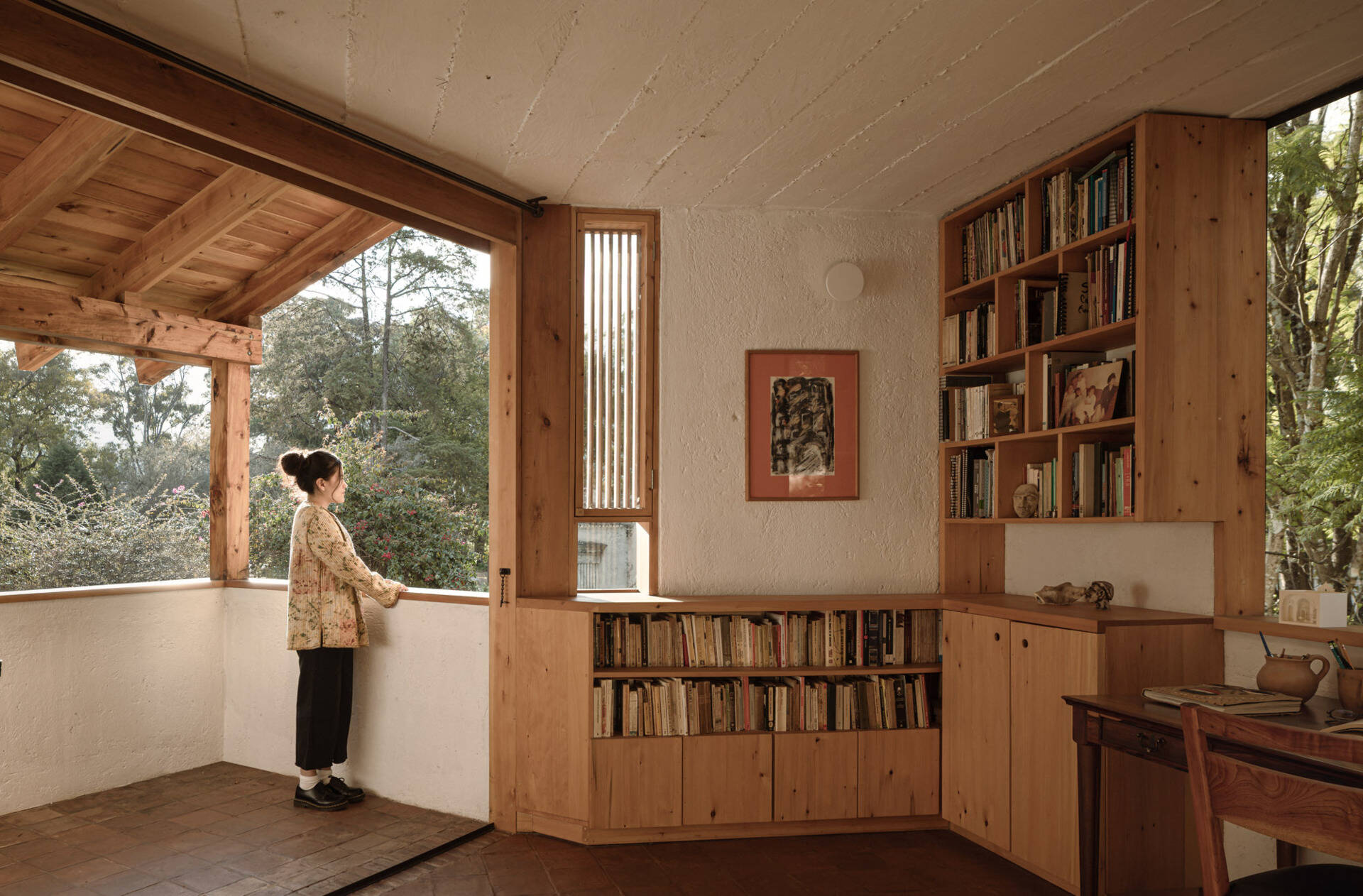 Tour the upstairs suite at Casa Amona, with cypress bookshelves, a desk overlooking the trees and a covered terrace facing the wooded hillside.