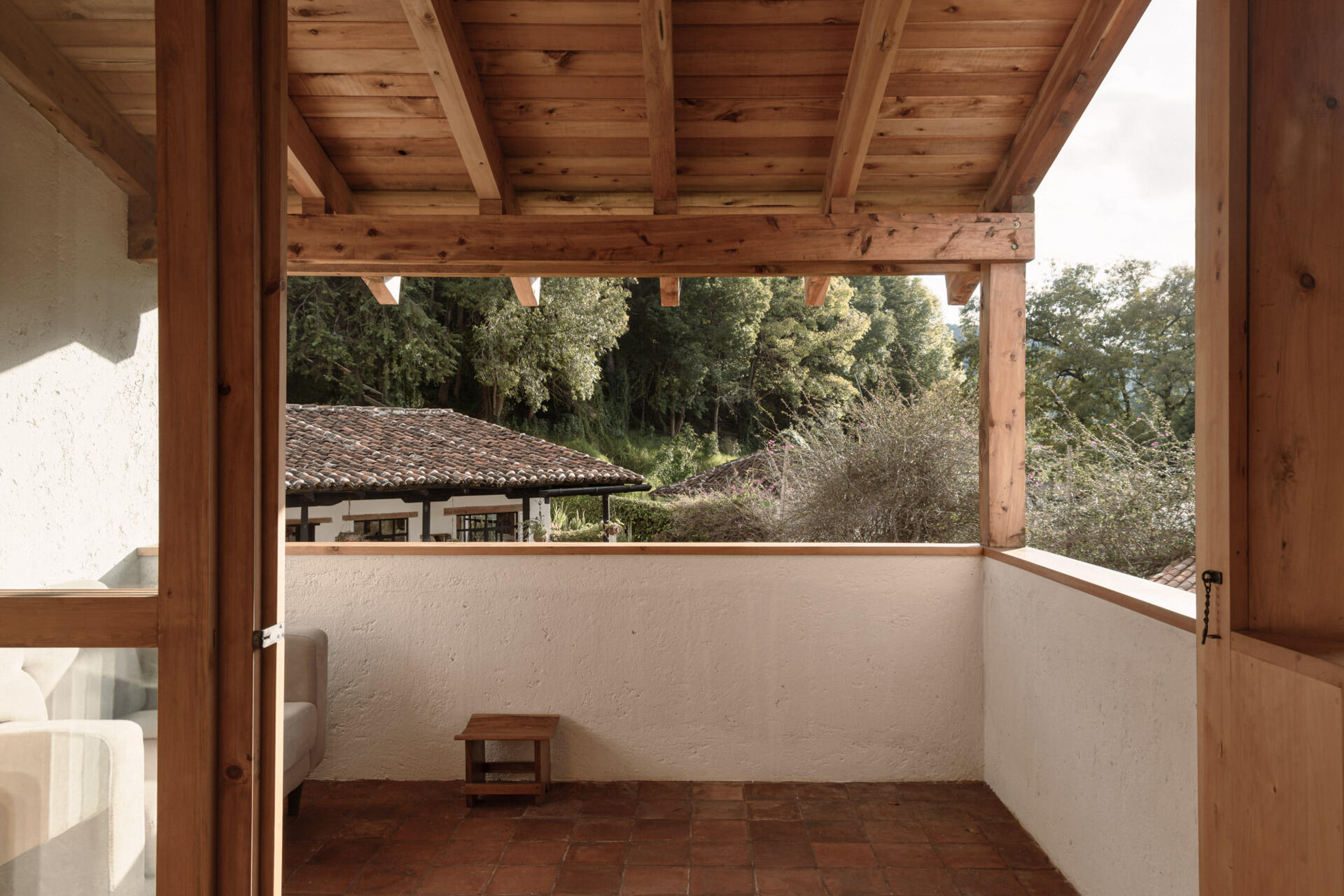 Tour the upstairs suite at Casa Amona, with cypress bookshelves, a desk overlooking the trees and a covered terrace facing the wooded hillside.