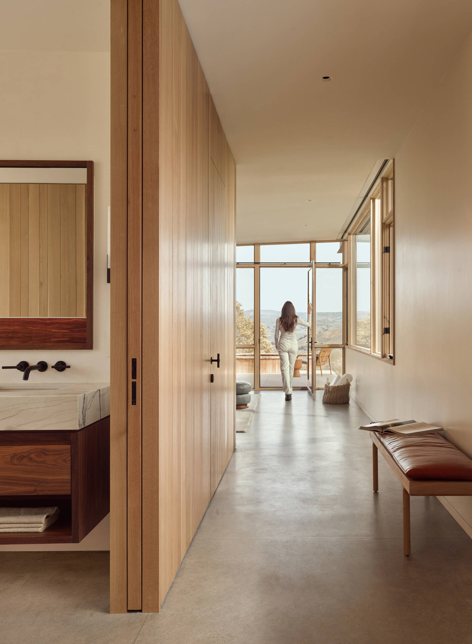 Explore the private bedroom area and nearby hot tub at Vineyard Residence, where the compact plan continues its direct relationship between interior rooms and sheltered outdoor spaces.