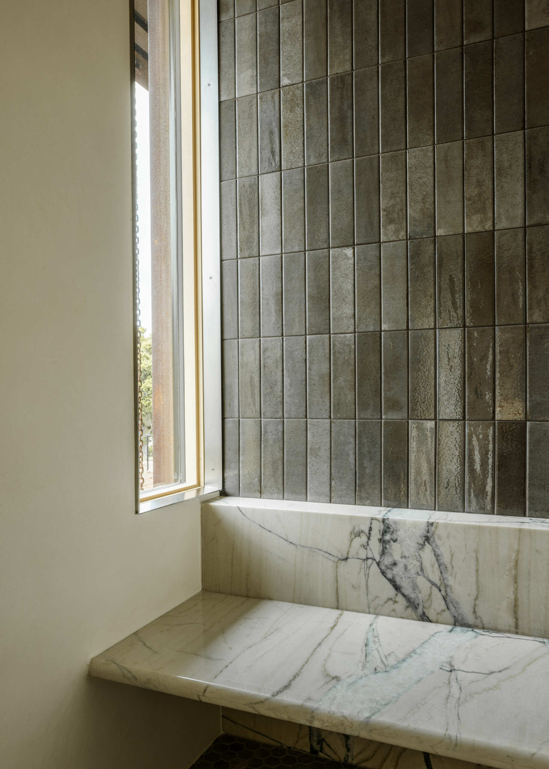 Natural materials, clean-lined finishes and understated detailing define the primary bathroom at Vineyard Residence by Clayton Korte.