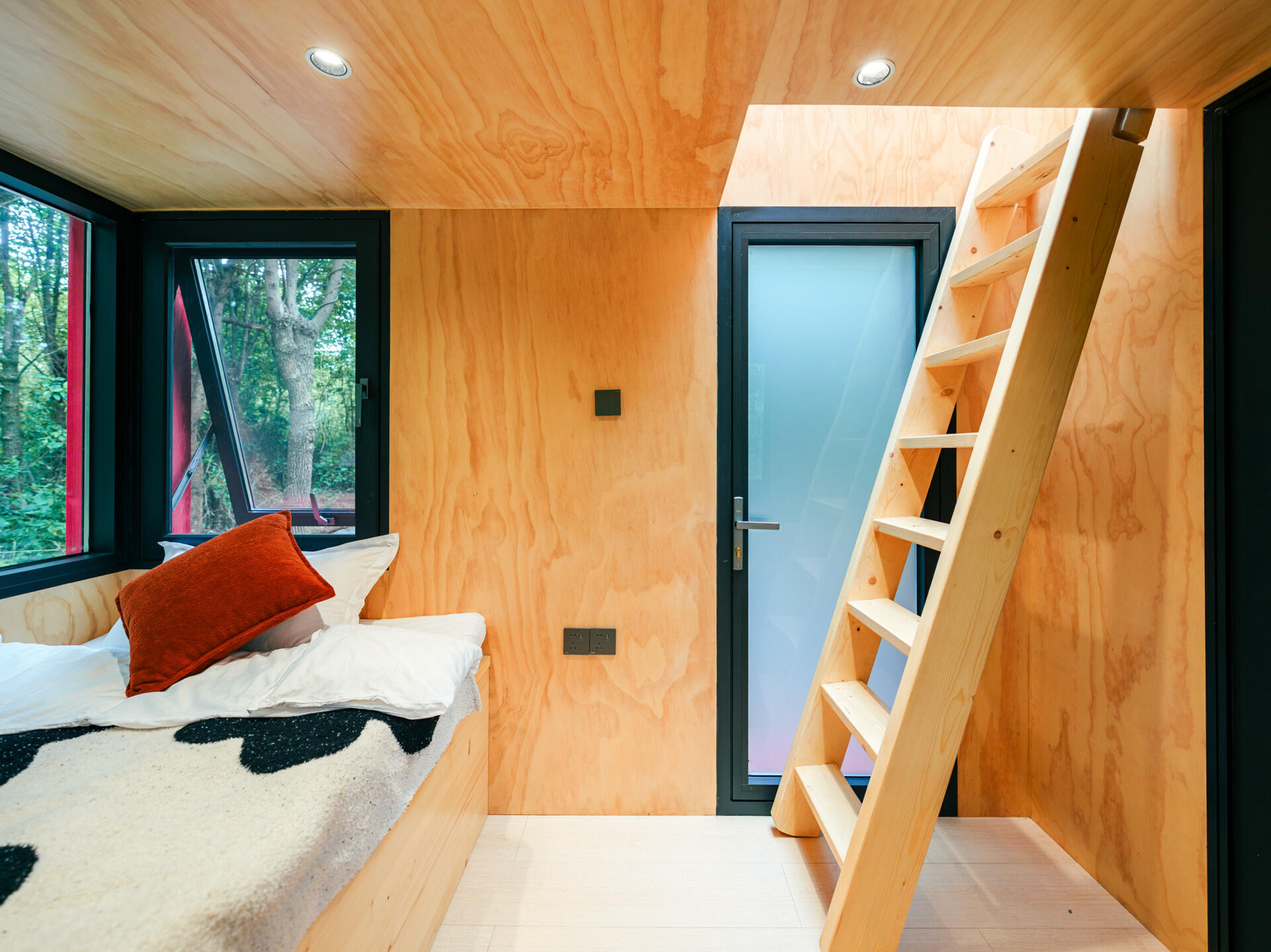 Step inside Wiki World’s Red Submarine Cabin, where circular portholes, panoramic windows and forest views create the feeling of sailing through the trees.