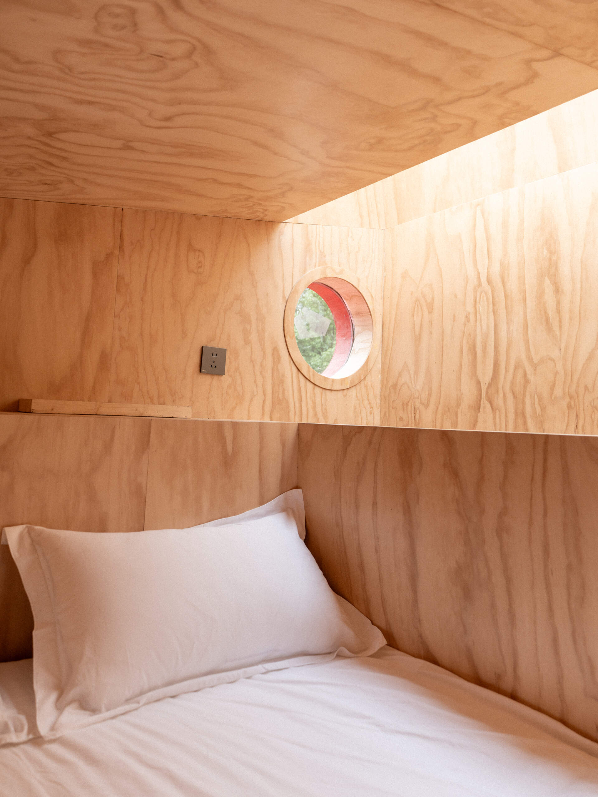 Step inside Wiki World’s Red Submarine Cabin, where circular portholes, panoramic windows and forest views create the feeling of sailing through the trees.
