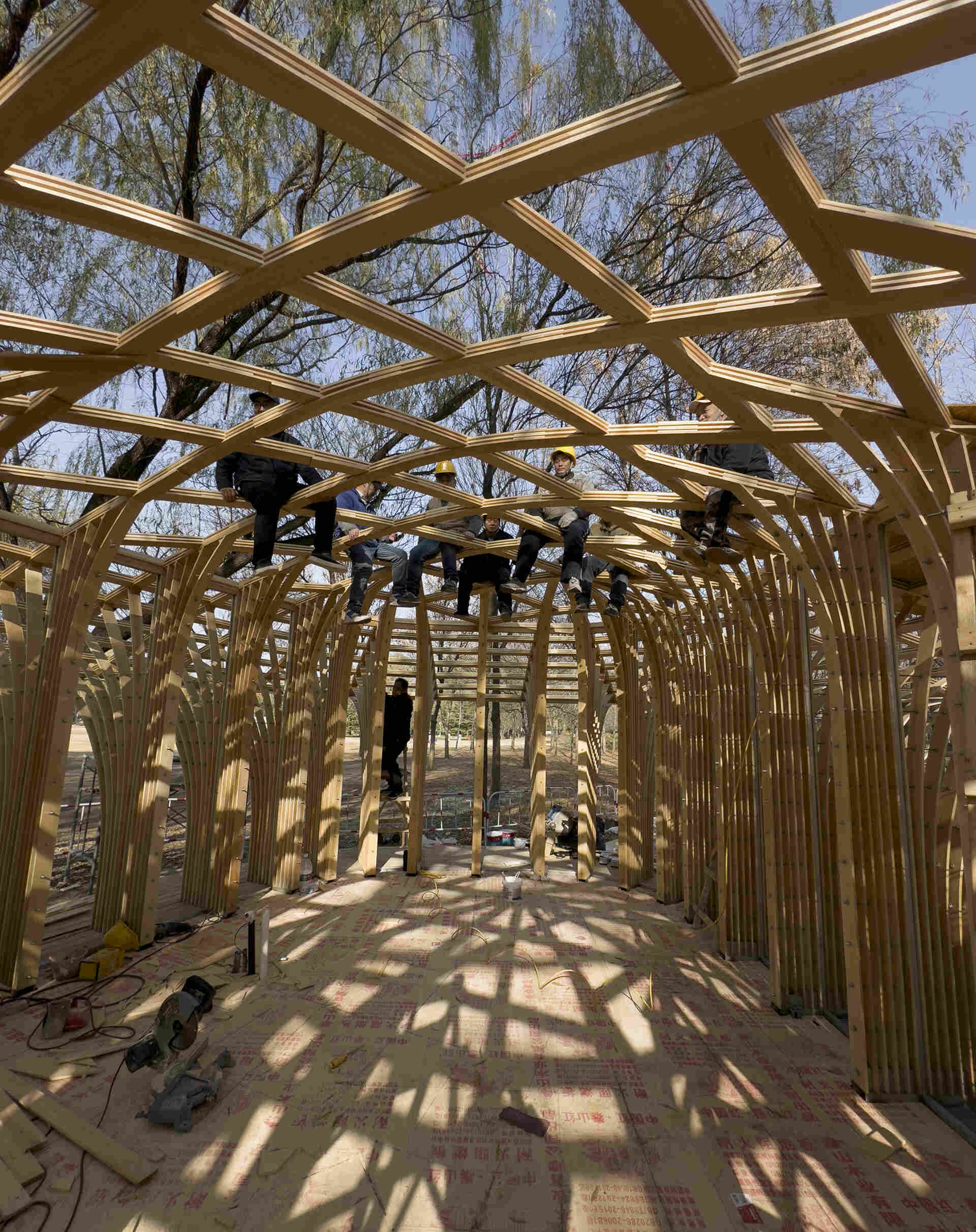 West Garden Florist by LUO studio is a mushroom-like timber florist pavilion tucked among the trees of Haidian Park in Beijing, with a planted roof and open canopy.