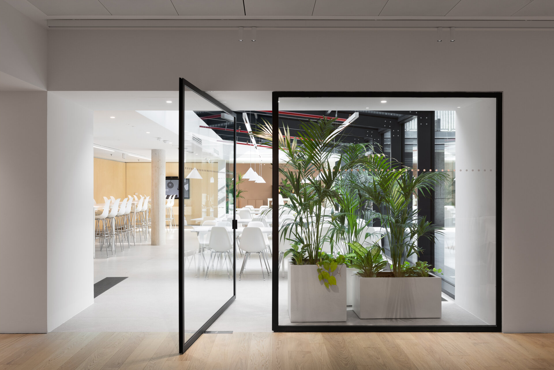 Explore RG27, ACPV ARCHITECTS' new Milan headquarters, featuring contemporary office interiors, open-plan workspaces, a central garden courtyard, architectural model archives, and a materials library.