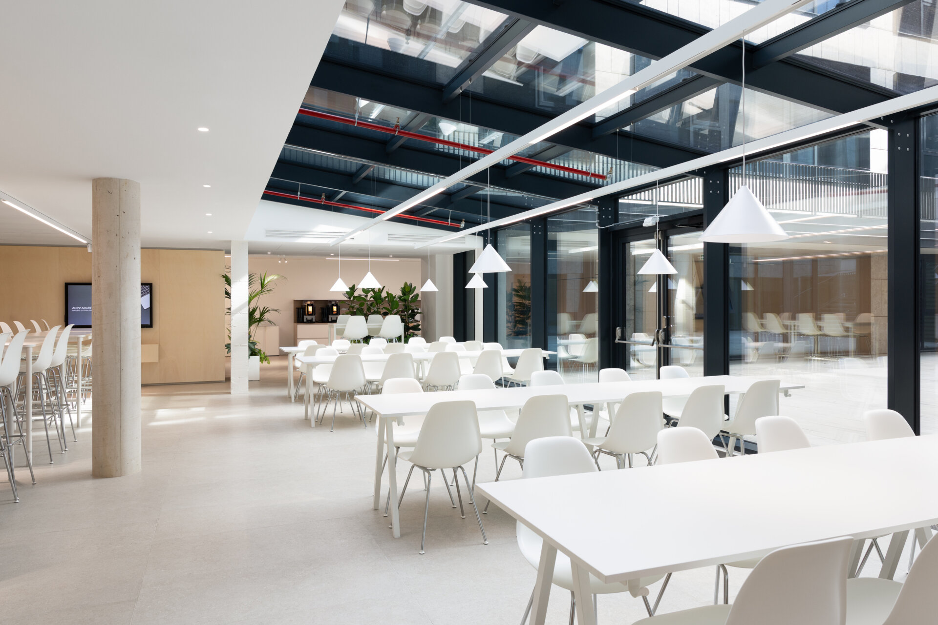 Explore RG27, ACPV ARCHITECTS' new Milan headquarters, featuring contemporary office interiors, open-plan workspaces, a central garden courtyard, architectural model archives, and a materials library.