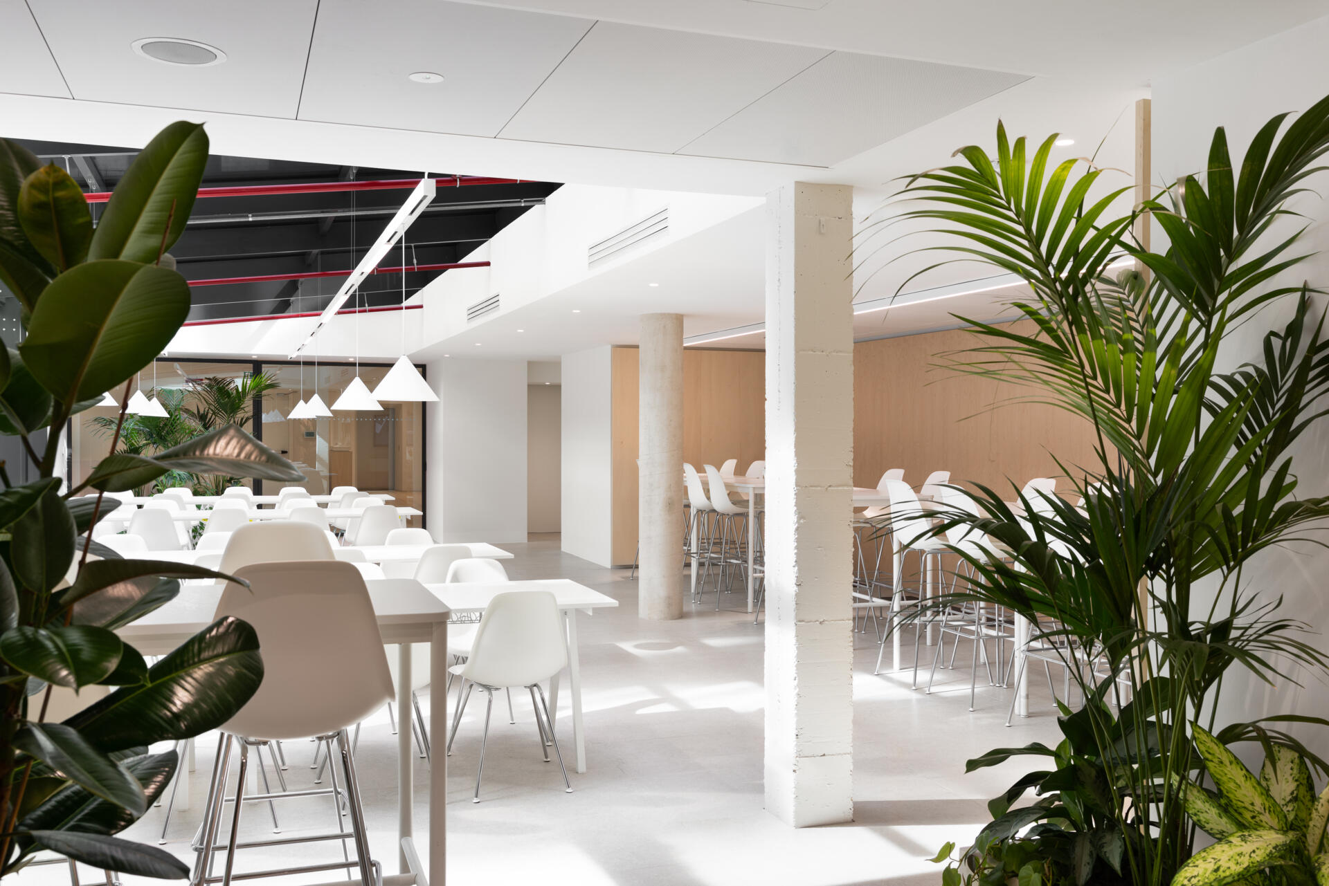 Explore RG27, ACPV ARCHITECTS' new Milan headquarters, featuring contemporary office interiors, open-plan workspaces, a central garden courtyard, architectural model archives, and a materials library.