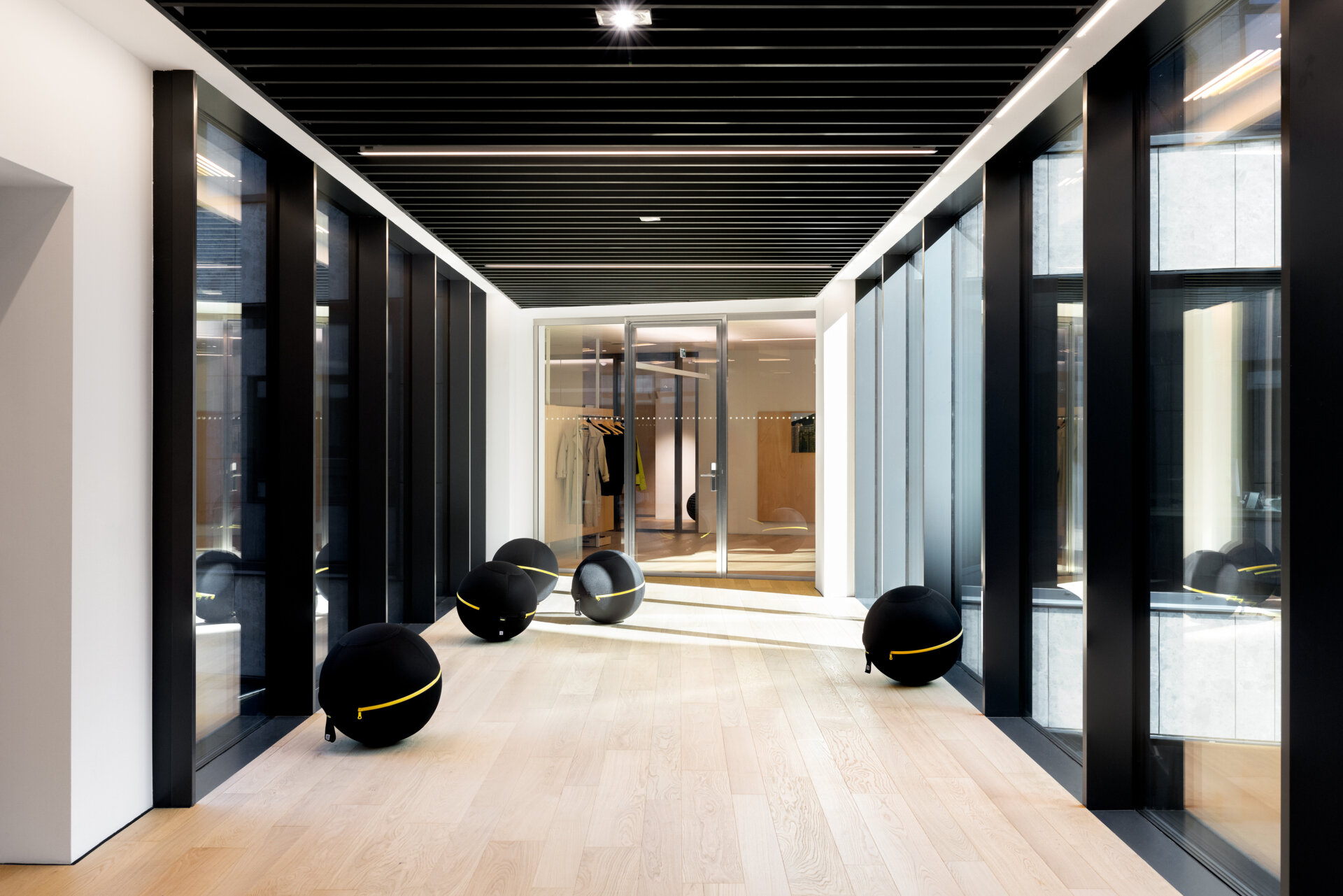 Explore RG27, ACPV ARCHITECTS' new Milan headquarters, featuring contemporary office interiors, open-plan workspaces, a central garden courtyard, architectural model archives, and a materials library.