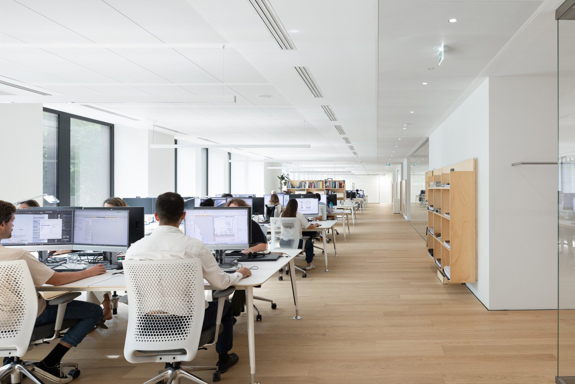 Explore RG27, ACPV ARCHITECTS' new Milan headquarters, featuring contemporary office interiors, open-plan workspaces, a central garden courtyard, architectural model archives, and a materials library.