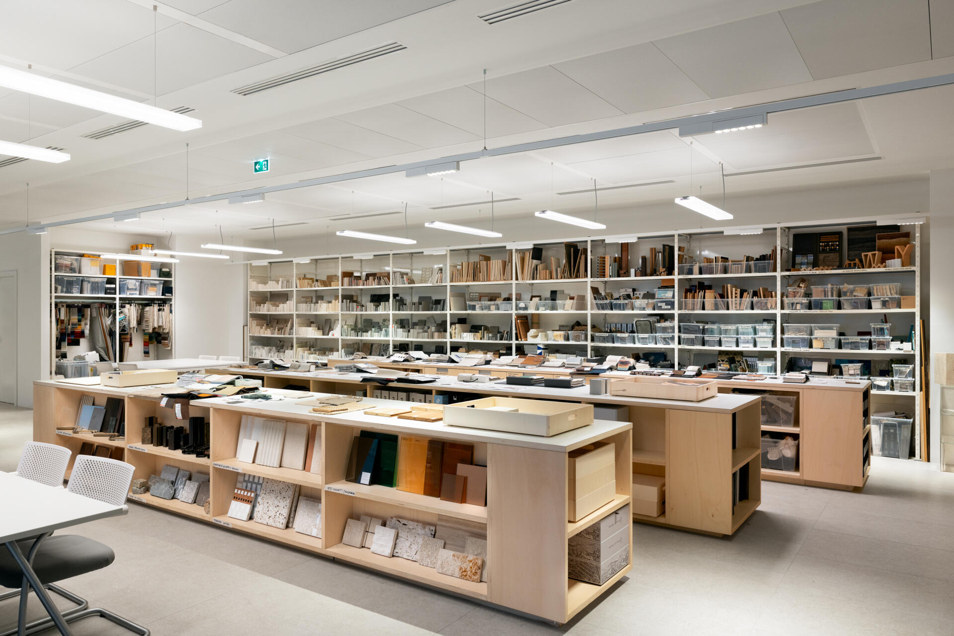 Explore RG27, ACPV ARCHITECTS' new Milan headquarters, featuring contemporary office interiors, open-plan workspaces, a central garden courtyard, architectural model archives, and a materials library.