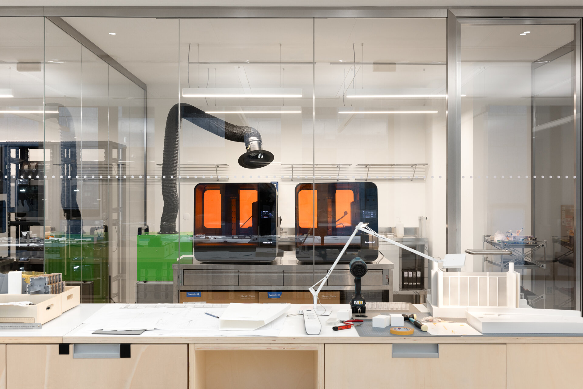 Explore RG27, ACPV ARCHITECTS' new Milan headquarters, featuring contemporary office interiors, open-plan workspaces, a central garden courtyard, architectural model archives, and a materials library.