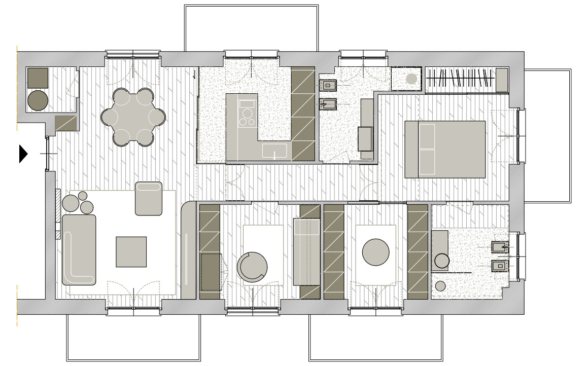 The Apartment Floor Plan
The floor plan shows how the 100 m² apartment is organized into two main zones, with the communal living and dining spaces occupying one side and the private bedrooms and bathrooms arranged along the other. The kitchen sits between these areas, enclosed by its glass walls while remaining immediately accessible from the dining room. A central hallway connects the living spaces with the bedrooms, study areas, and bathrooms, with built-in cabinetry used extensively throughout the layout. Since the apartment was purchased with many of its partitions and technical systems already installed, KKArchitettura worked within the existing arrangement, refining circulation routes and incorporating multifunctional furniture to make better use of the available space.