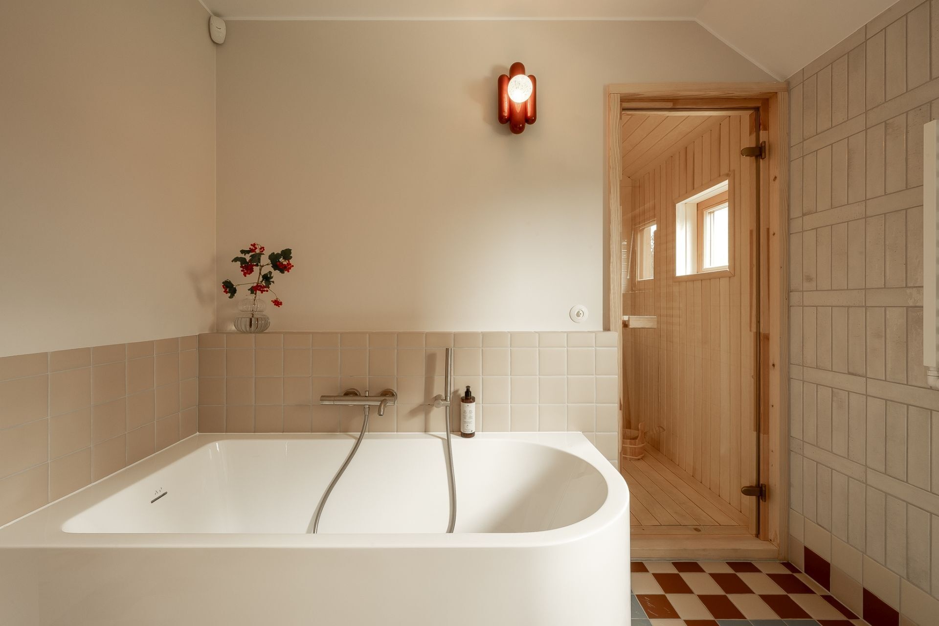 Contemporary bathroom and sauna inspiration featuring a large white bathtub, timber-lined private sauna, glass shower, terracotta vessel sink, and custom wood bathroom cabinetry.