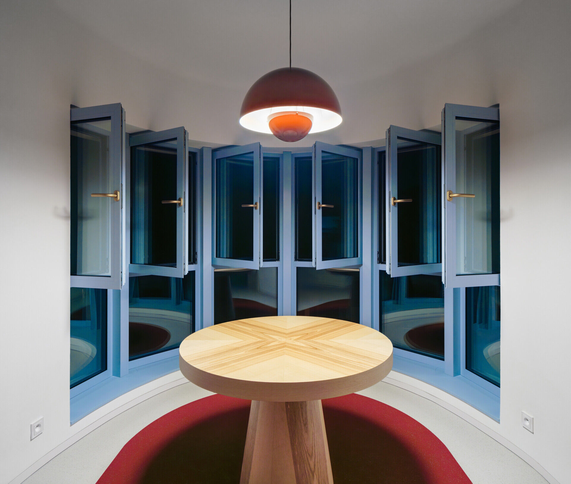 Explore the colorful living spaces of Blue Window House, where mustard-yellow seating, red pendant lights, warm wood cabinetry, and pale blue kitchens create playful contemporary interiors. Curved furniture, built-in storage, and custom joinery add character throughout the renovated home.