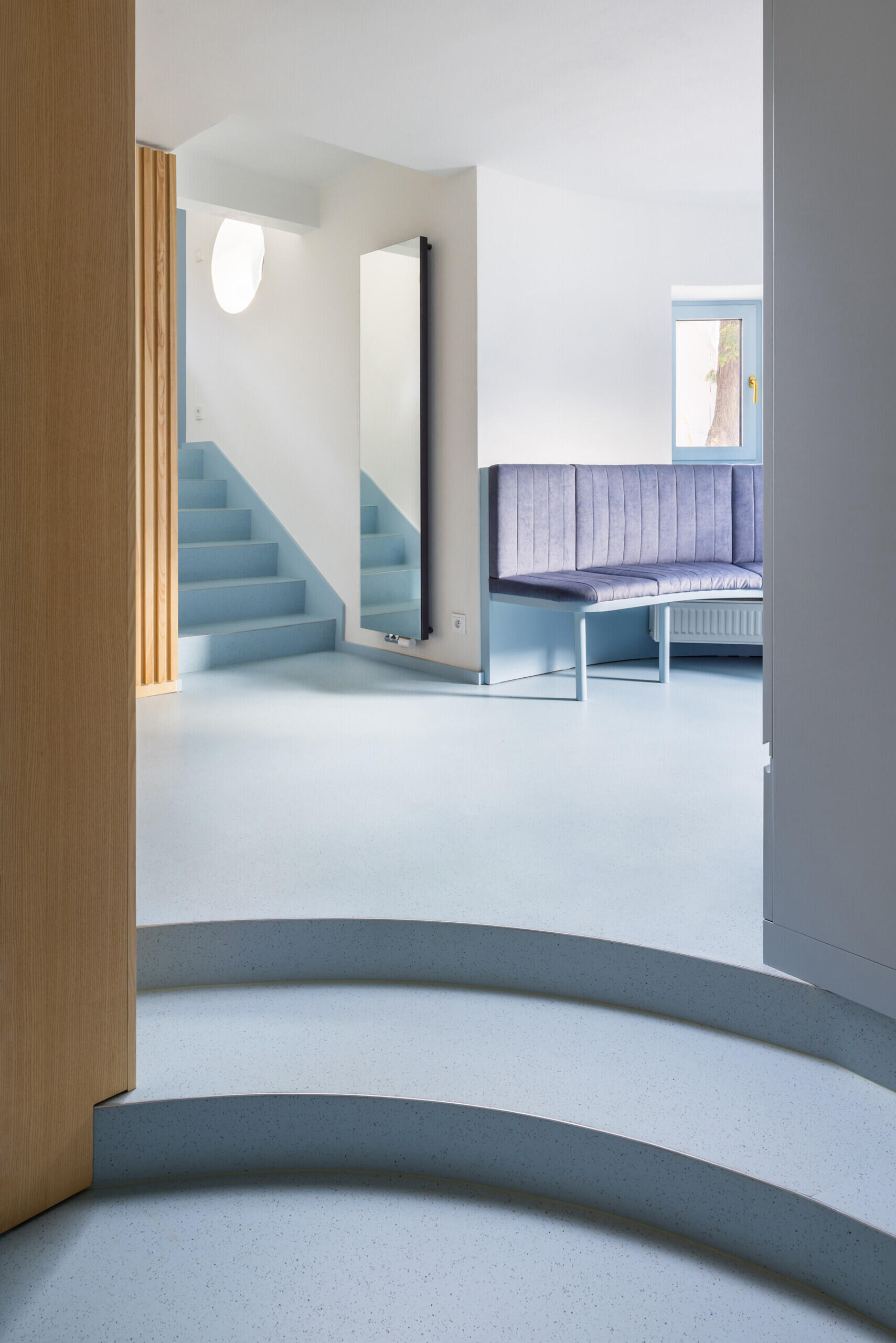 Step inside a renovated modernist house featuring three distinct interiors, including a shared living area and two apartments. Explore how No Architects uses custom furniture, contemporary finishes, and a consistent approach to materials to create a cohesive interior design.