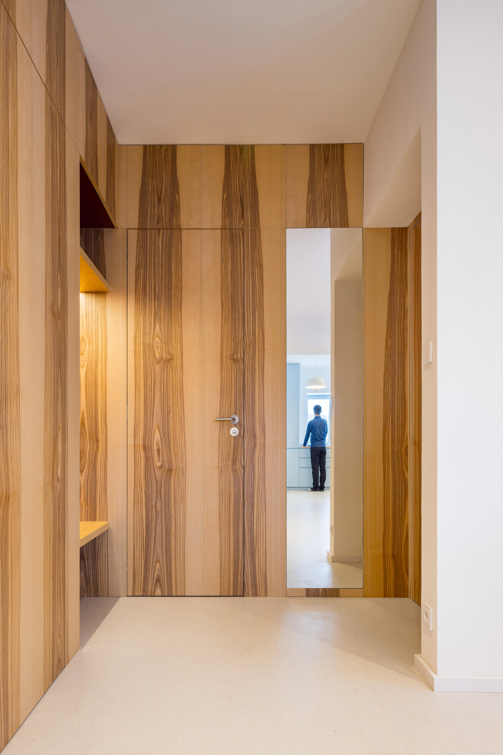 Explore the colorful living spaces of Blue Window House, where mustard-yellow seating, red pendant lights, warm wood cabinetry, and pale blue kitchens create playful contemporary interiors. Curved furniture, built-in storage, and custom joinery add character throughout the renovated home.