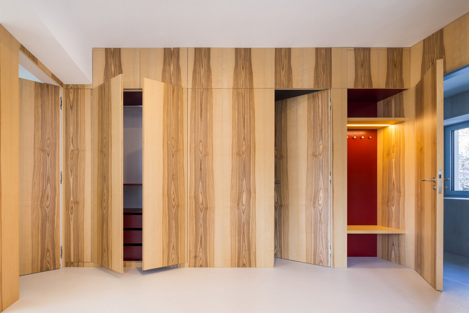 Explore the colorful living spaces of Blue Window House, where mustard-yellow seating, red pendant lights, warm wood cabinetry, and pale blue kitchens create playful contemporary interiors. Curved furniture, built-in storage, and custom joinery add character throughout the renovated home.