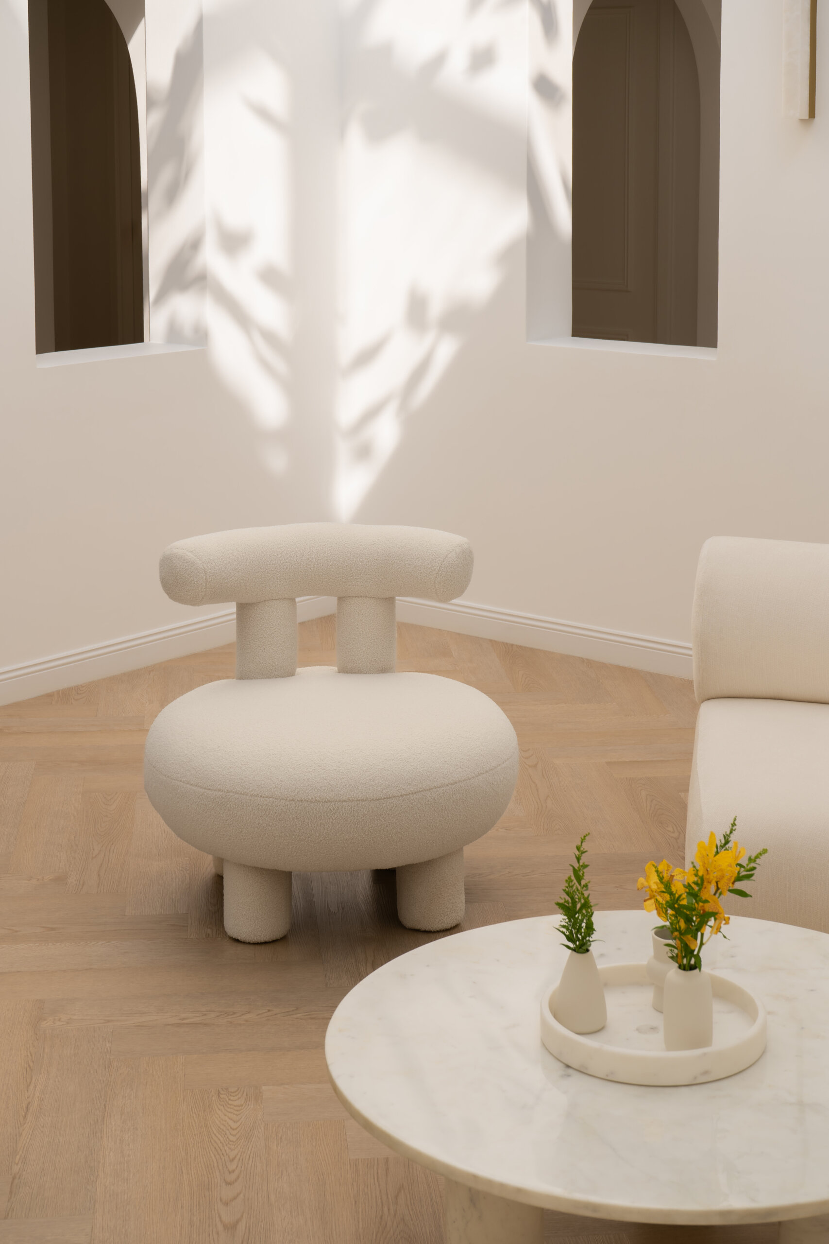 Discover the central courtyard inside The White Arcade, a Dubai villa renovated by D’Ora Tokai Designs. Featuring double-height ceilings, a glass roof, sculptural arches, a bespoke C-shaped sofa, indoor trees, and a floating leaf installation, this unique living space is filled with natural light.