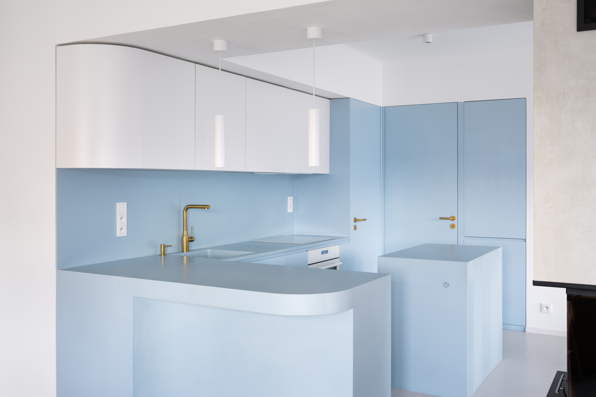 Explore the colorful living spaces of Blue Window House, where mustard-yellow seating, red pendant lights, warm wood cabinetry, and pale blue kitchens create playful contemporary interiors. Curved furniture, built-in storage, and custom joinery add character throughout the renovated home.