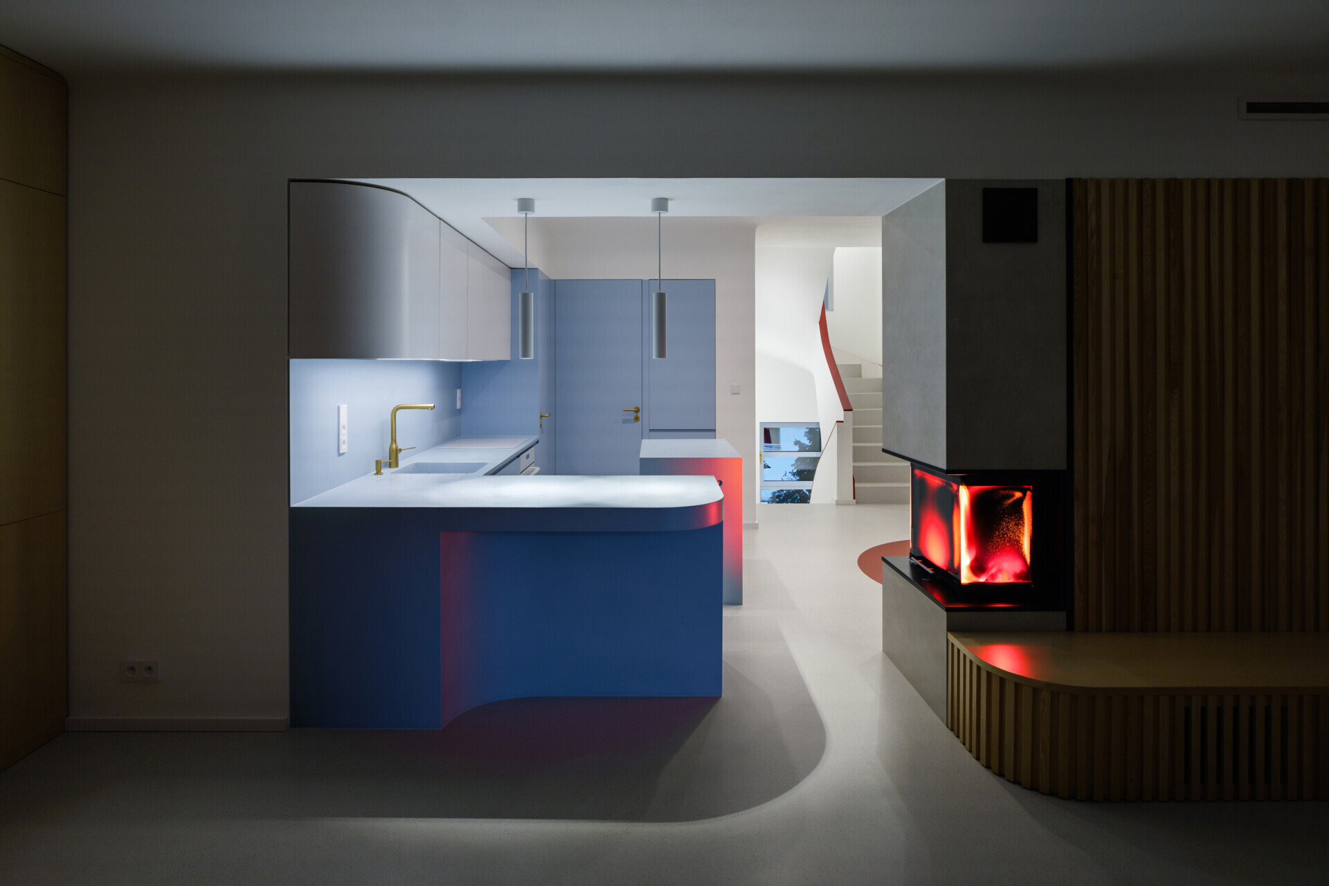 Explore the colorful living spaces of Blue Window House, where mustard-yellow seating, red pendant lights, warm wood cabinetry, and pale blue kitchens create playful contemporary interiors. Curved furniture, built-in storage, and custom joinery add character throughout the renovated home.