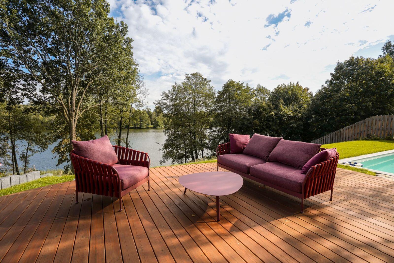 Explore the lakeside decks of this contemporary Polish holiday home, complete with outdoor lounge furniture, sun loungers, a hot tub, and a private jetty overlooking Lake D?browa Wielka.