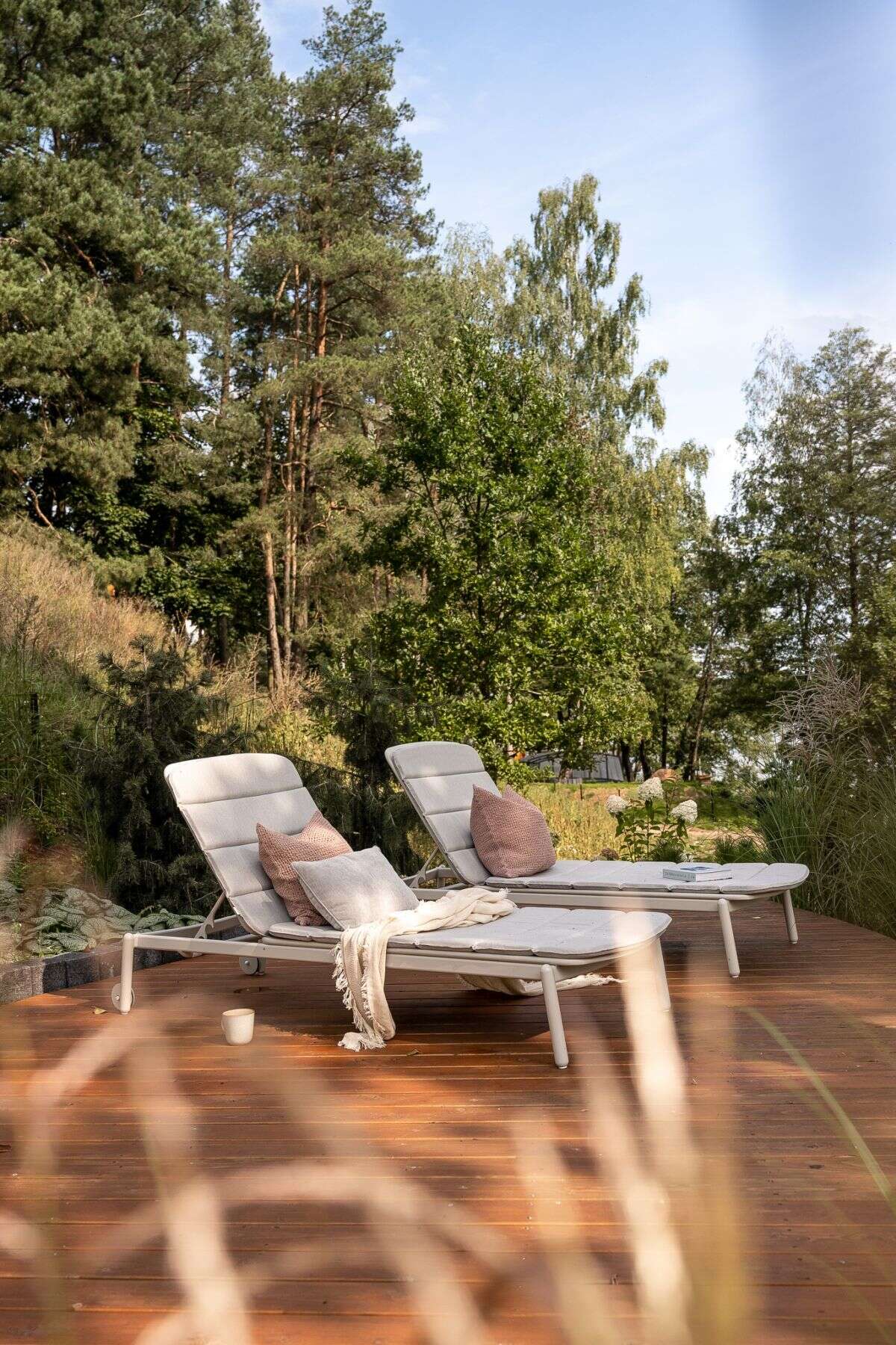 Explore the lakeside decks of this contemporary Polish holiday home, complete with outdoor lounge furniture, sun loungers, a hot tub, and a private jetty overlooking Lake D?browa Wielka.
