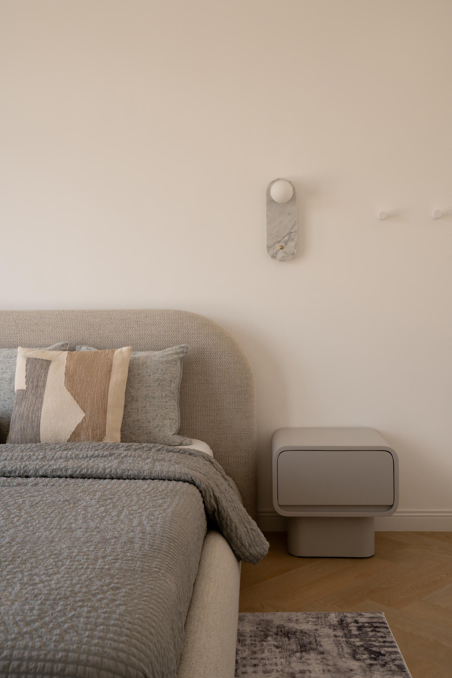 Neutral bedroom inspiration from The White Arcade in Dubai by D’Ora Tokai Designs. Explore contemporary bedrooms featuring rounded upholstered beds, textured bedding, sculptural bedside tables, marble wall lights, and soft beige and blue-grey colour palettes.