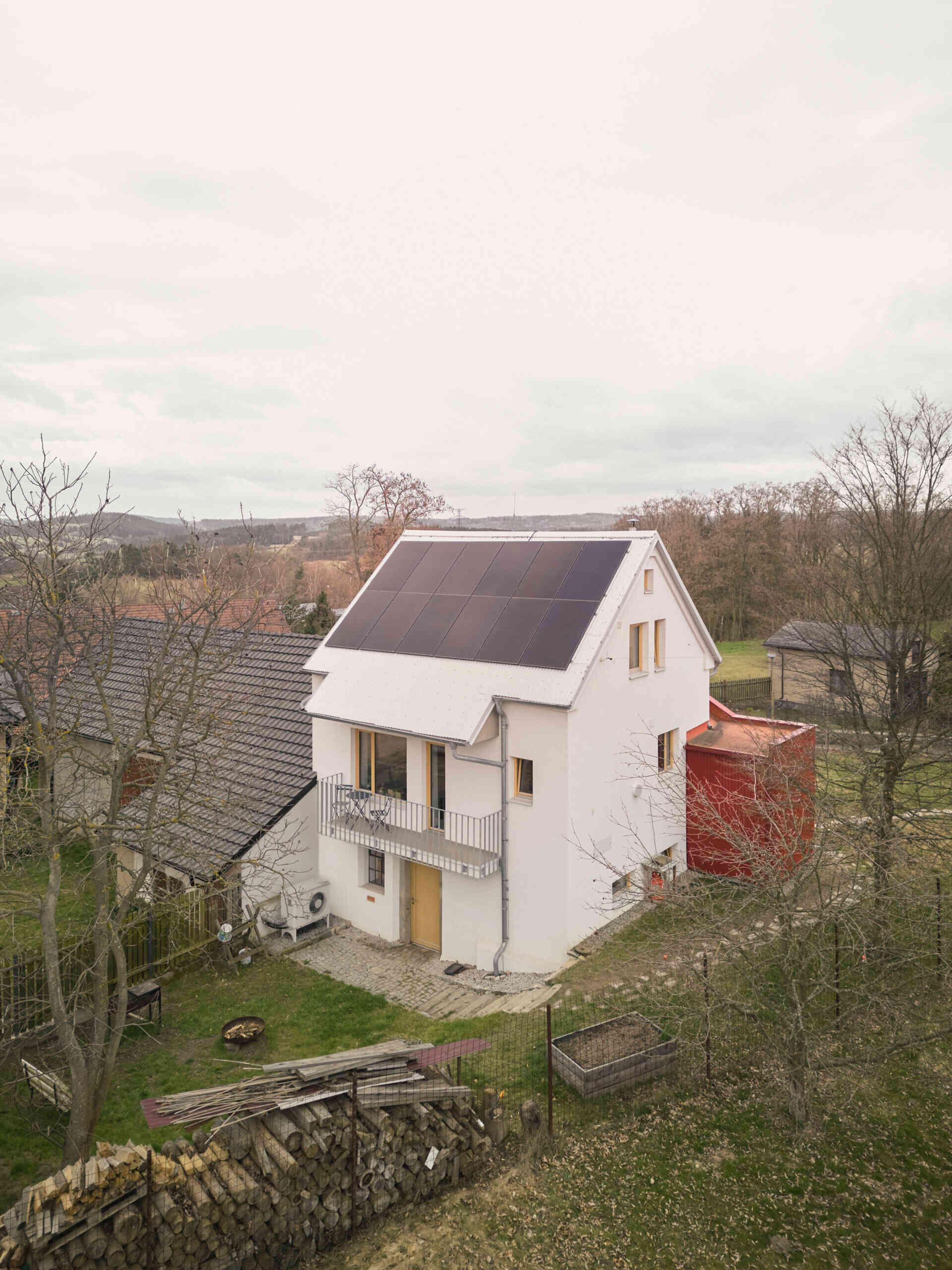 See how Facha architekti extended this small home in Ne?ín, Czech Republic, with a timber-framed addition wrapped in red corrugated metal. The new volume sits clearly against the older house, adding living space and a contemporary new layer to its evolving architecture.