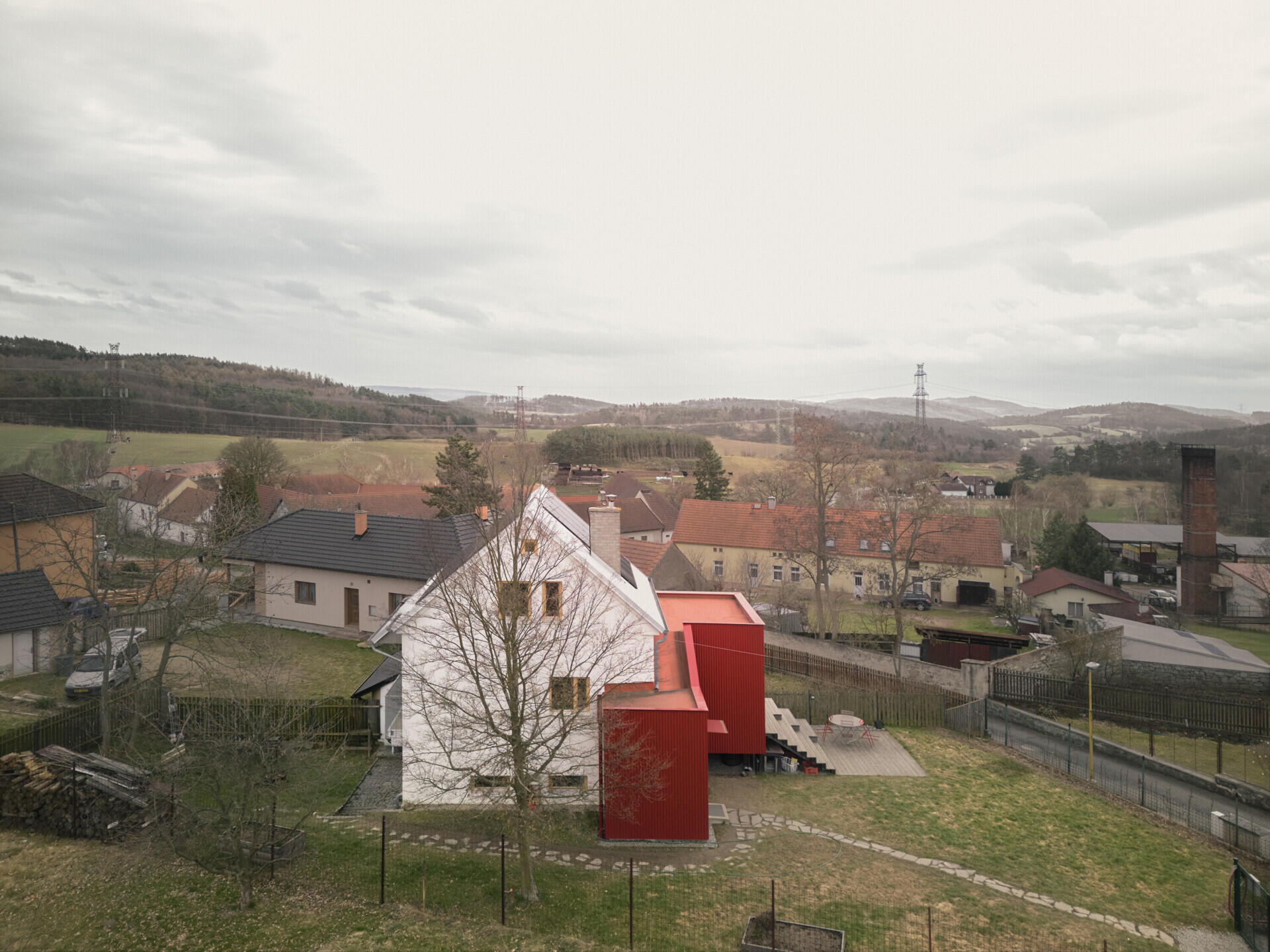See how Facha architekti extended this small home in Ne?ín, Czech Republic, with a timber-framed addition wrapped in red corrugated metal. The new volume sits clearly against the older house, adding living space and a contemporary new layer to its evolving architecture.