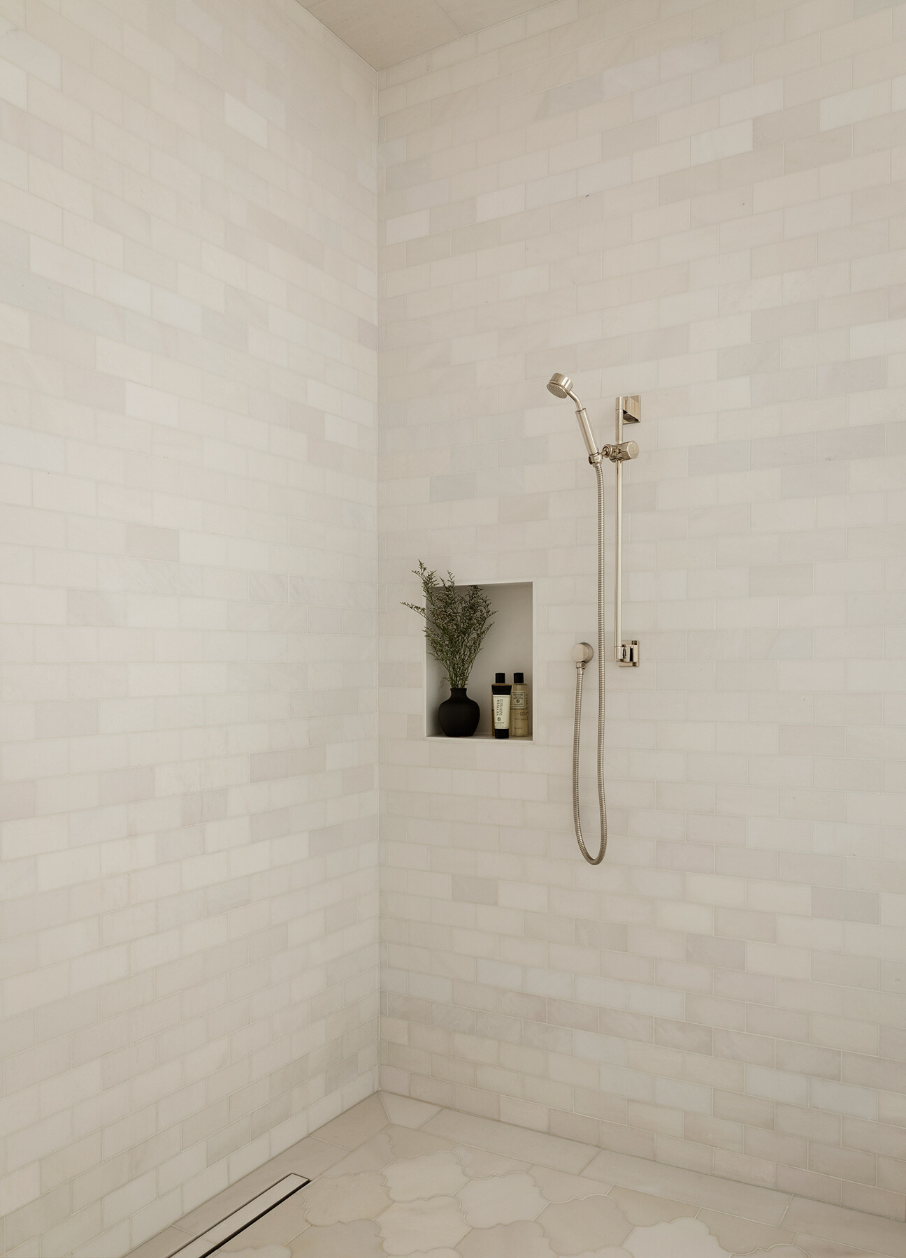 Explore the Atherton Residence bathroom by Paulina Carcach Studio, featuring a freestanding tub, walk-in shower, skylight, grey-veined marble walls and a long matte black double vanity.