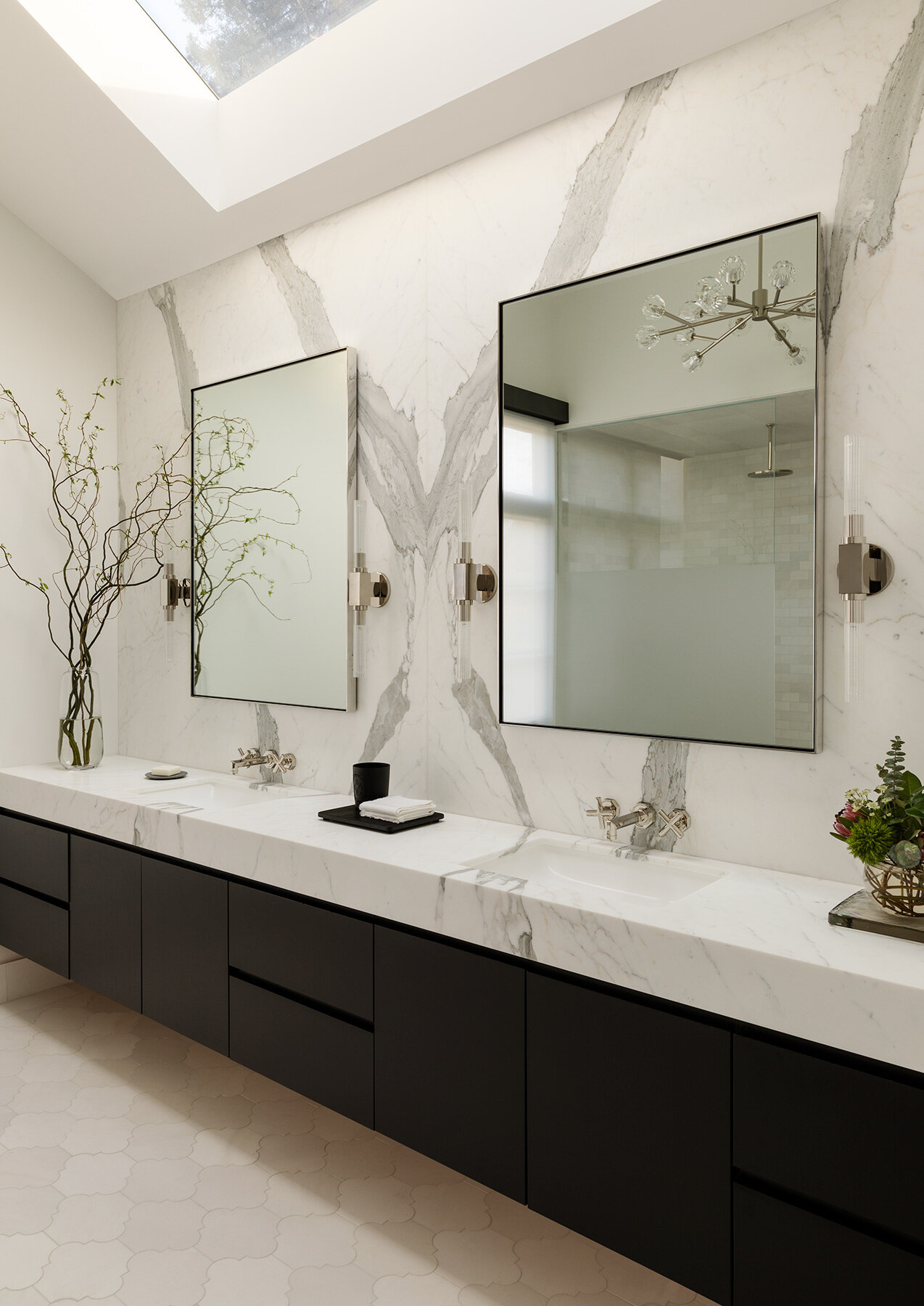 Explore the Atherton Residence bathroom by Paulina Carcach Studio, featuring a freestanding tub, walk-in shower, skylight, grey-veined marble walls and a long matte black double vanity.