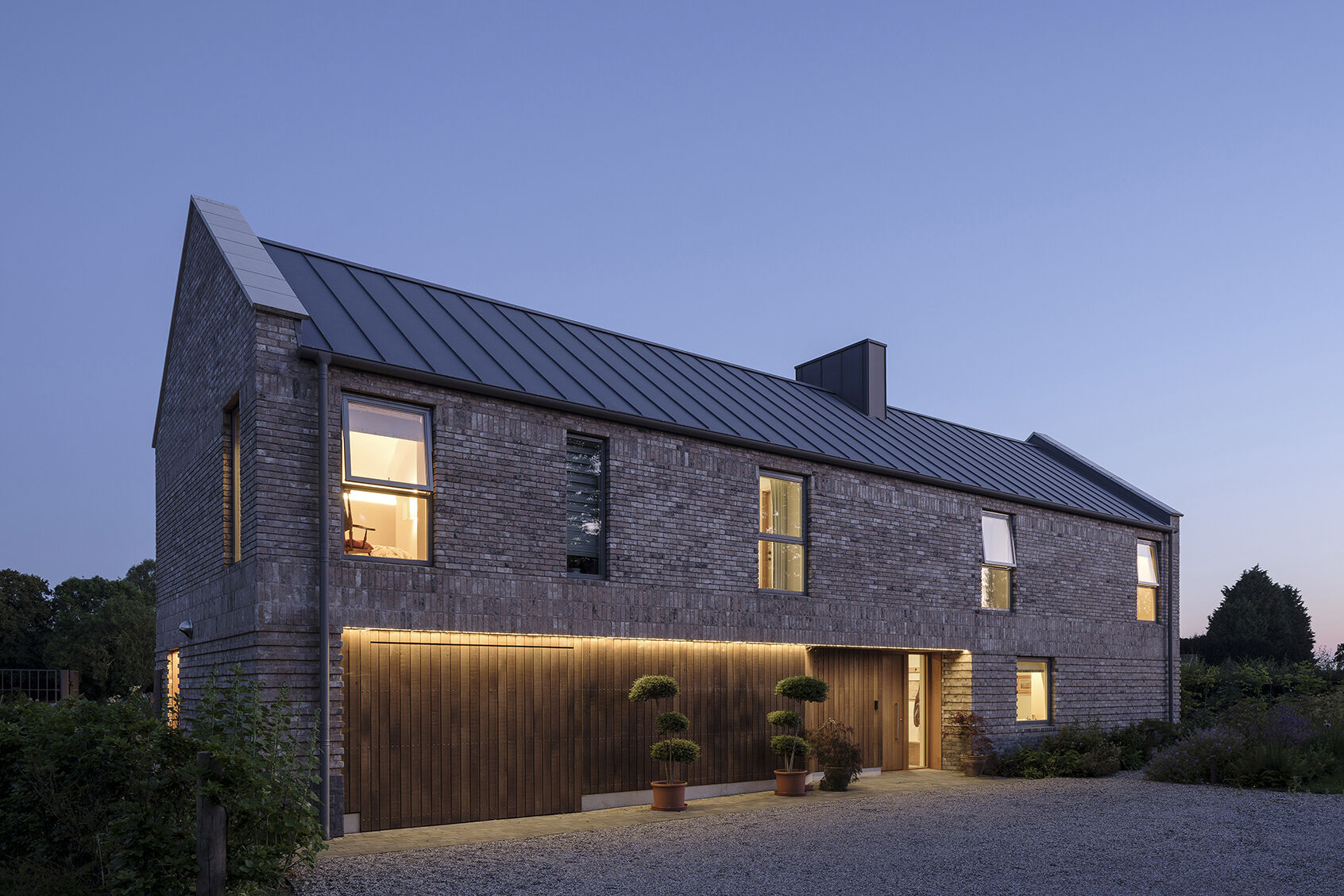 Explore the textured brickwork of this modern Suffolk house, where different brick patterns reference the history of traditional English longhouses.
